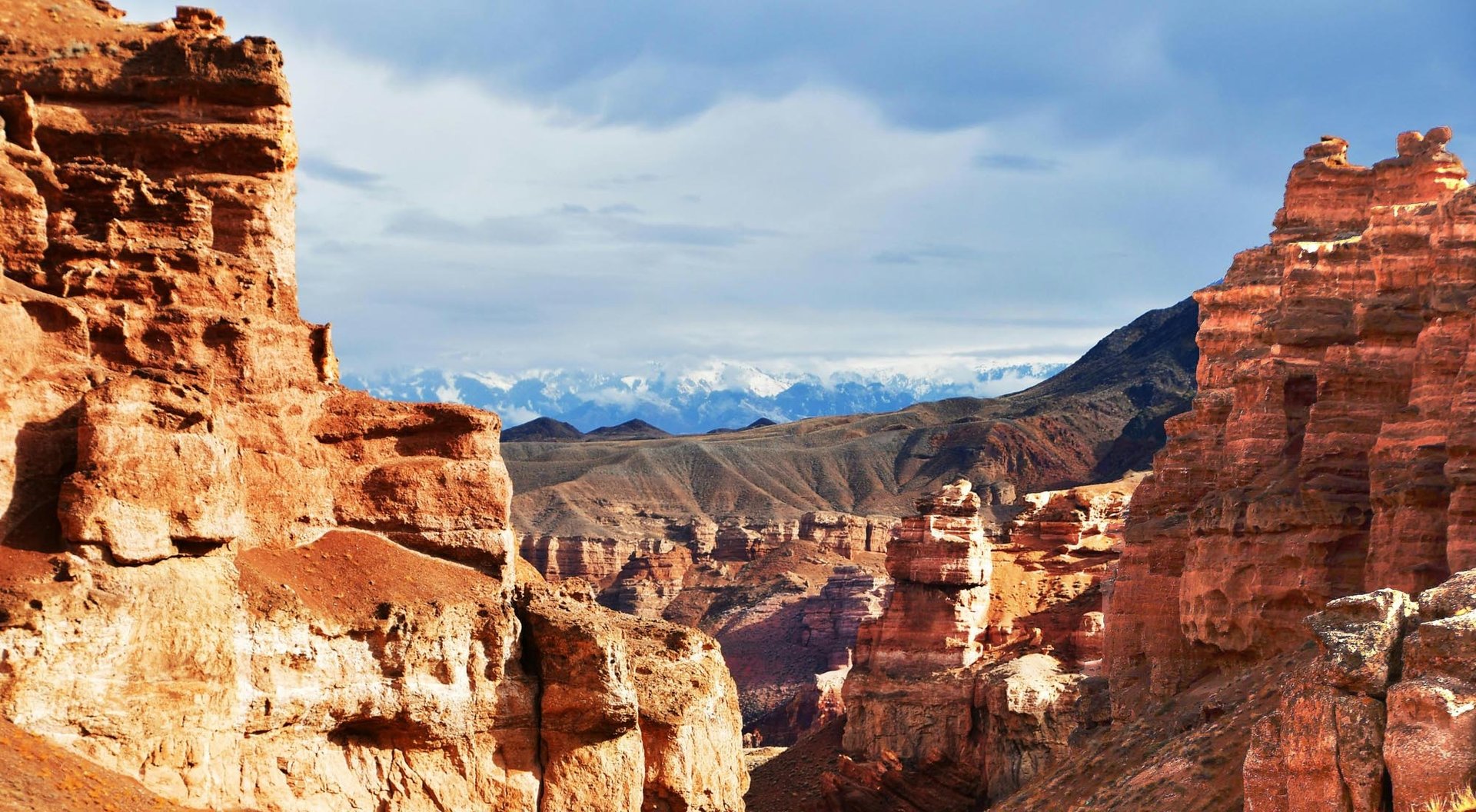 woman wearing yellow long-sleeved dress under white clouds and blue sky during daytime