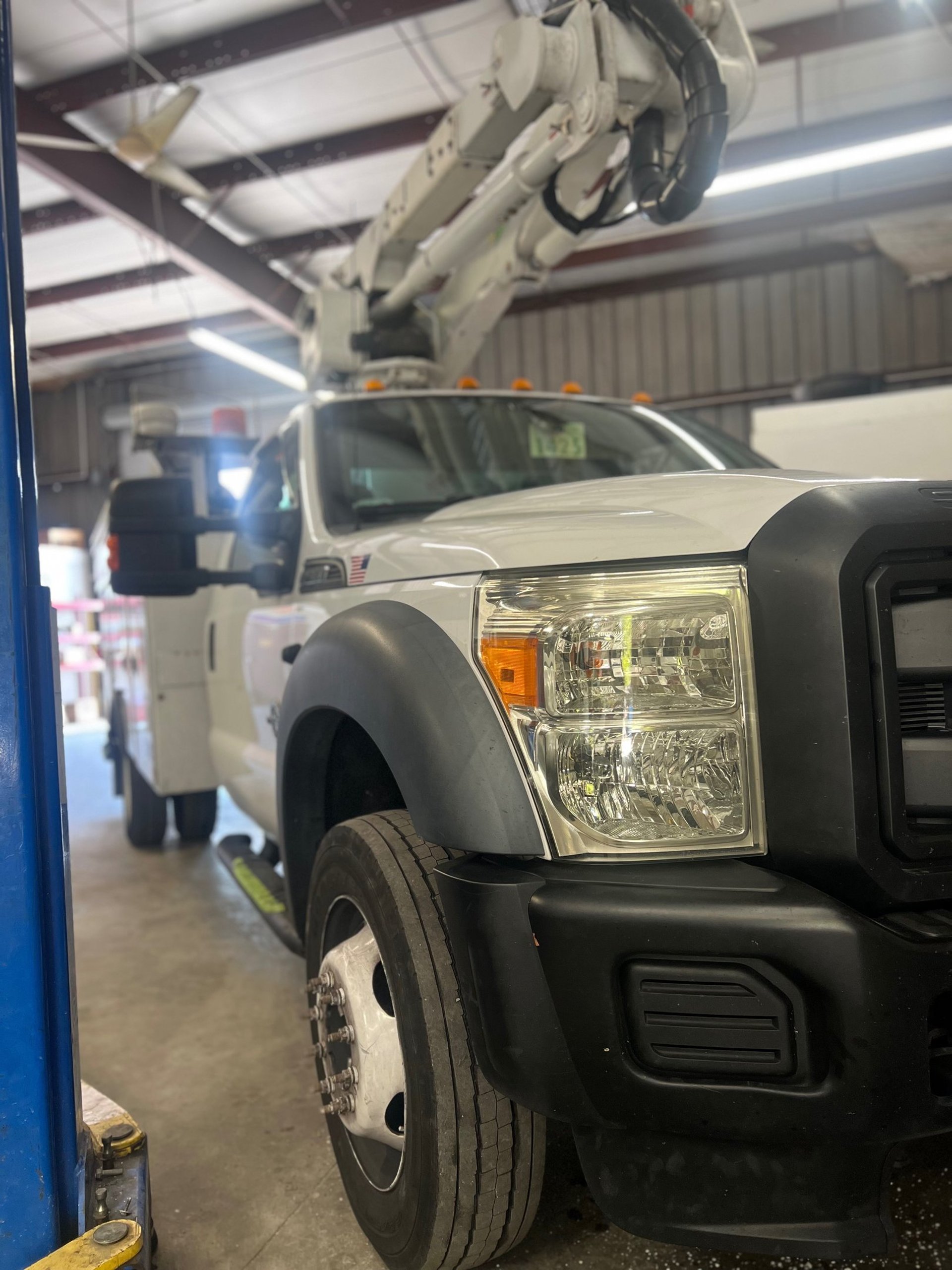 a group of four vehicles parked on a wet beach