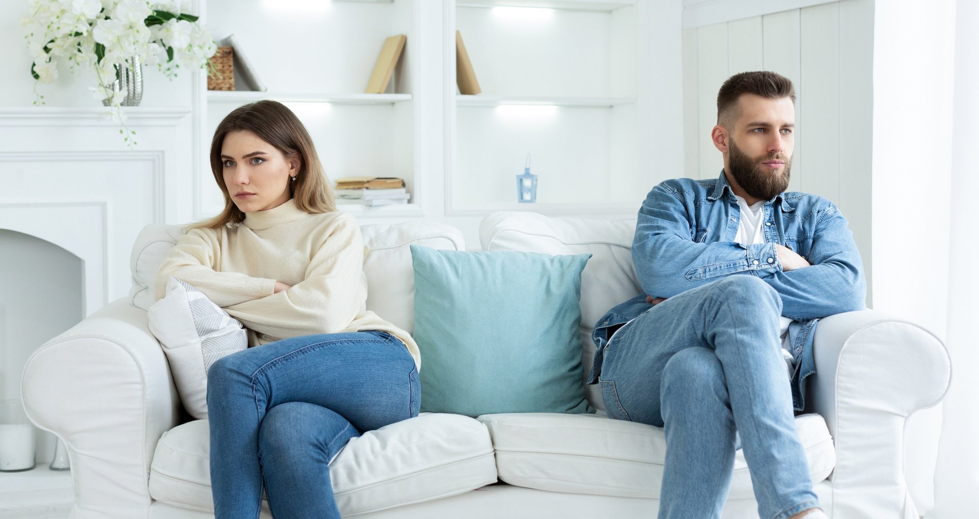 A couple is sitting on the couch in the therapy office during a couple's therapy session.