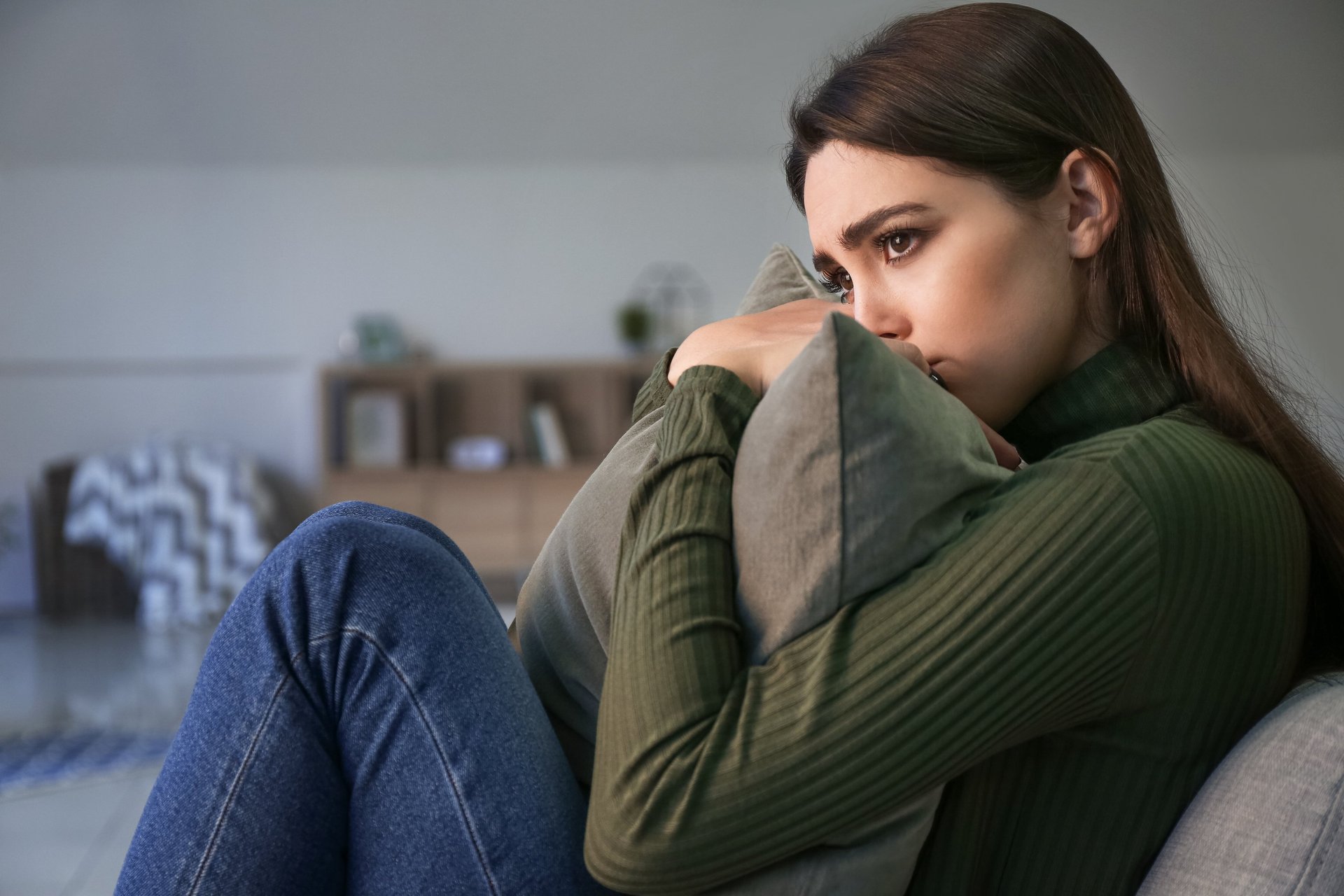 Depressed young woman at home