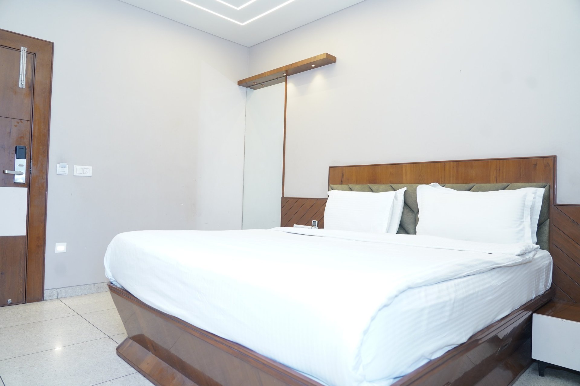 low-angle photo of Hotel lighted signage on top of brown building during nighttime