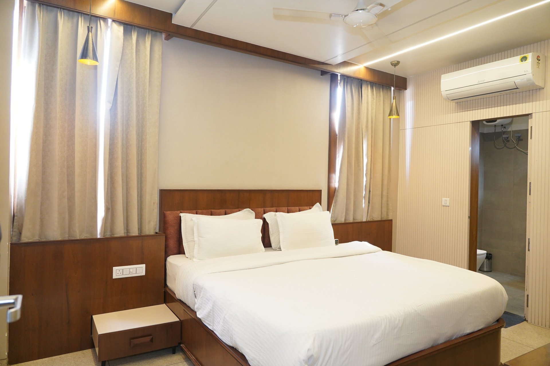 low-angle photo of Hotel lighted signage on top of brown building during nighttime