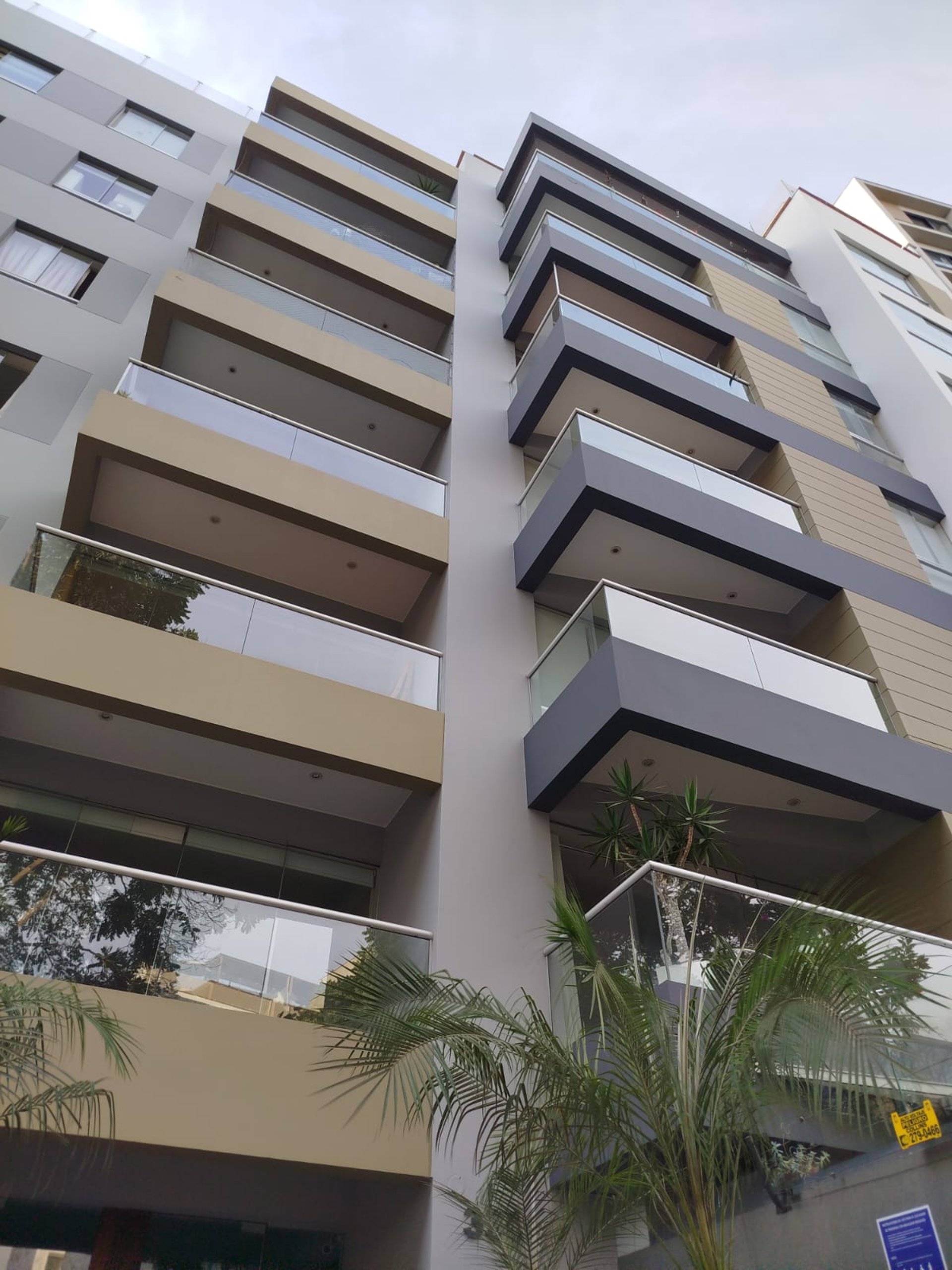 an abstract photo of a curved building with a blue sky in the background