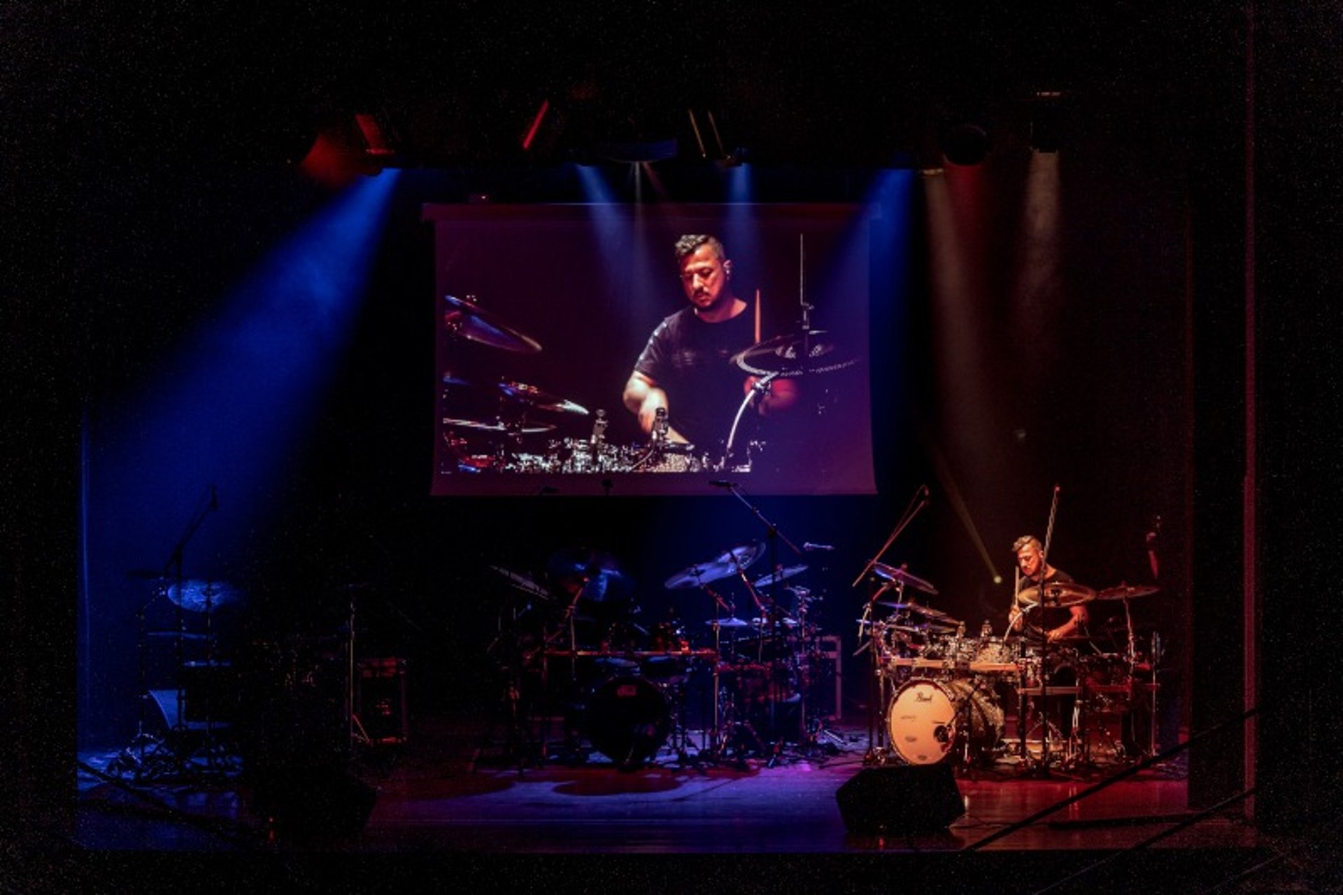 an abstract photo of a curved building with a blue sky in the background