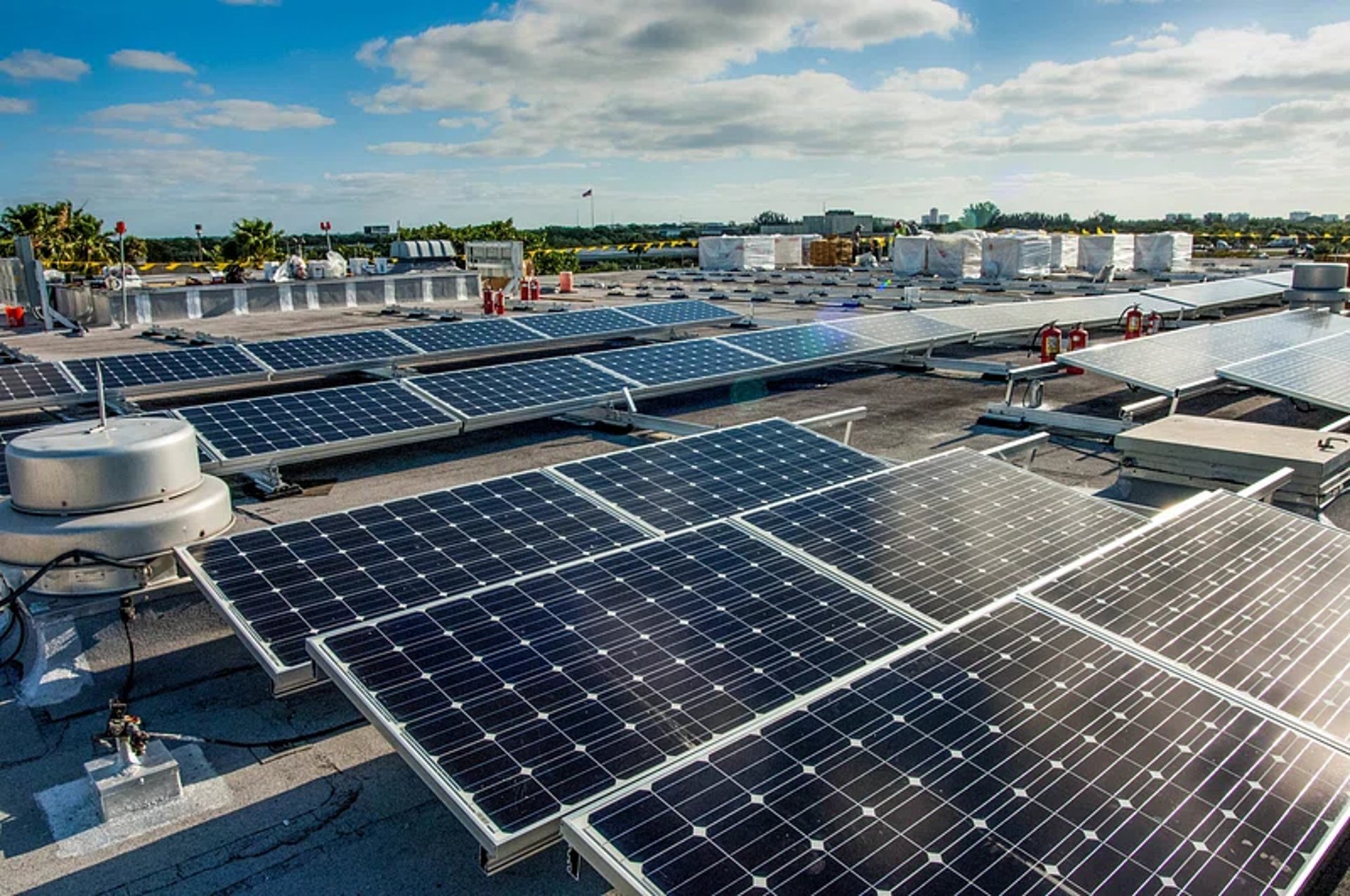 a plane flying in the sky at sunset
