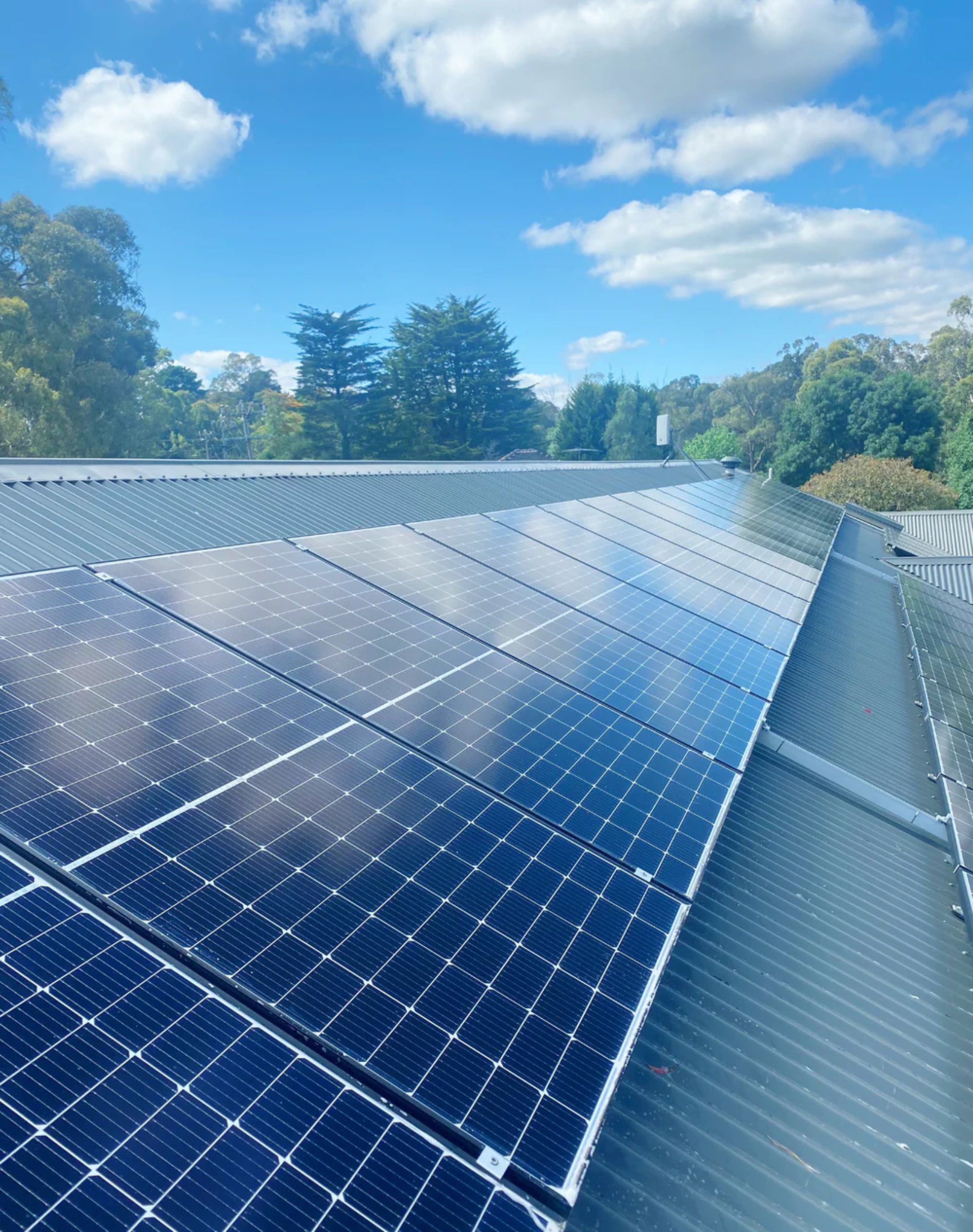 a plane flying in the sky at sunset