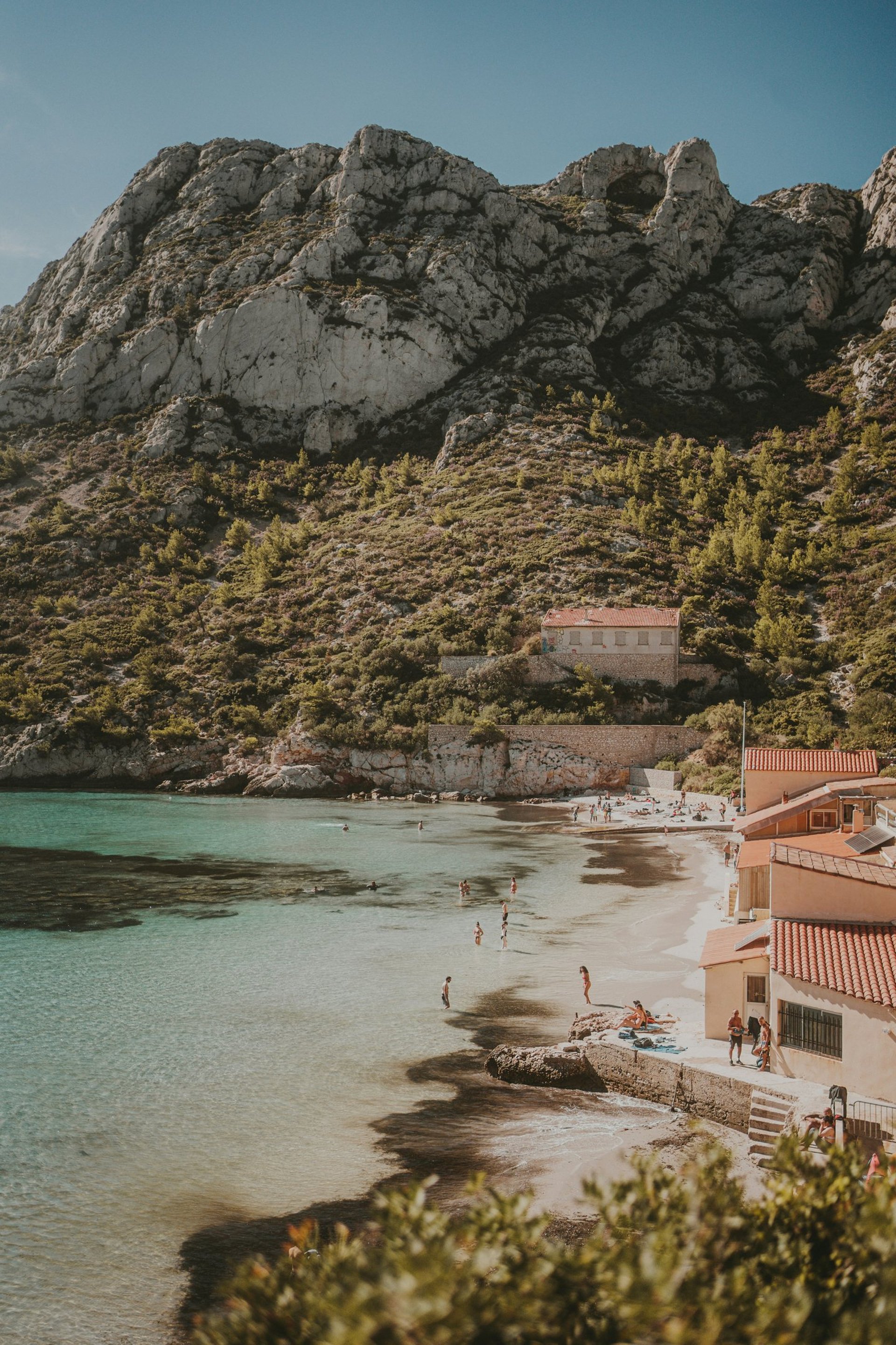 Stone stairs leading to clear water with fish