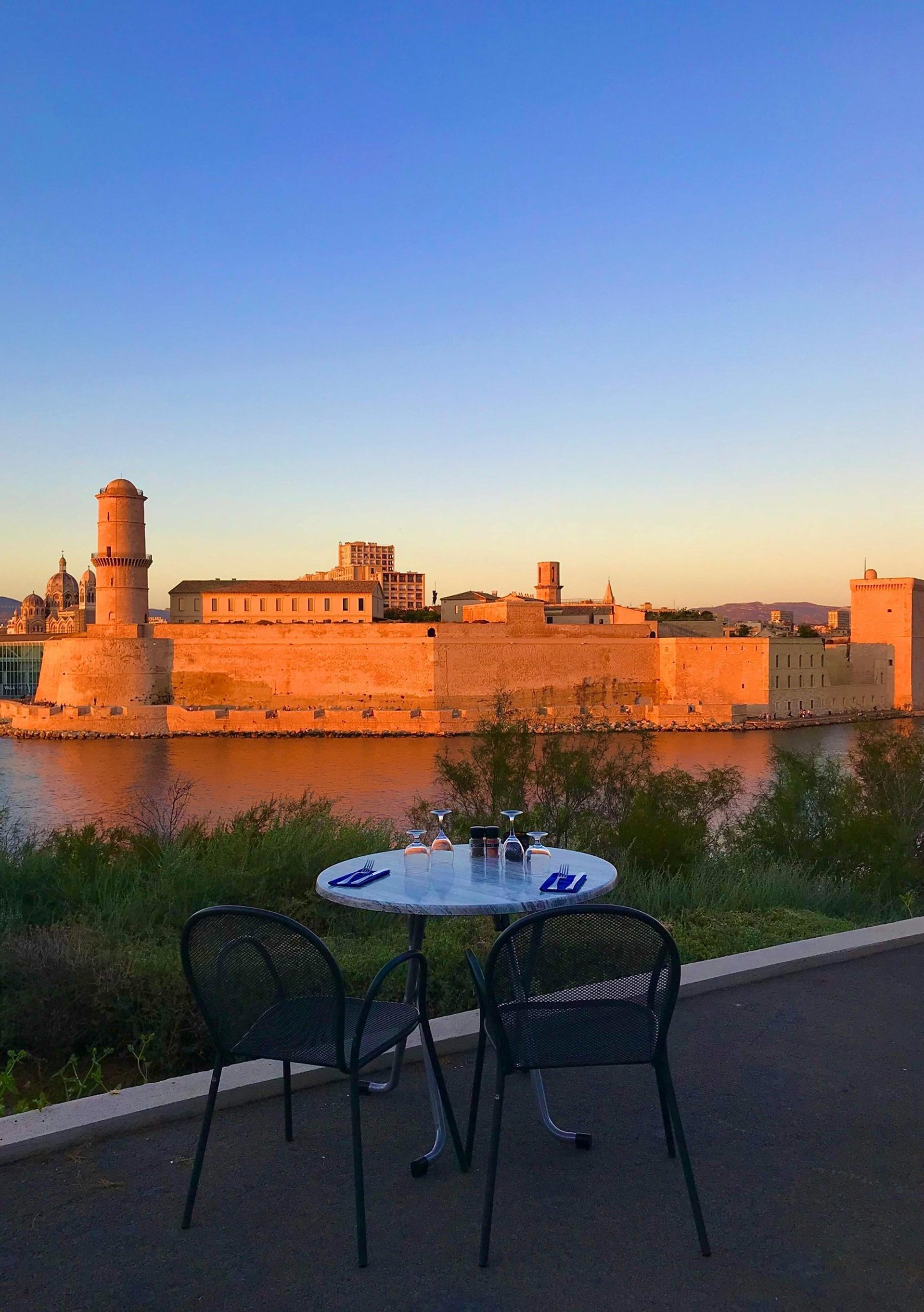 a rocky cliff overlooks a body of water