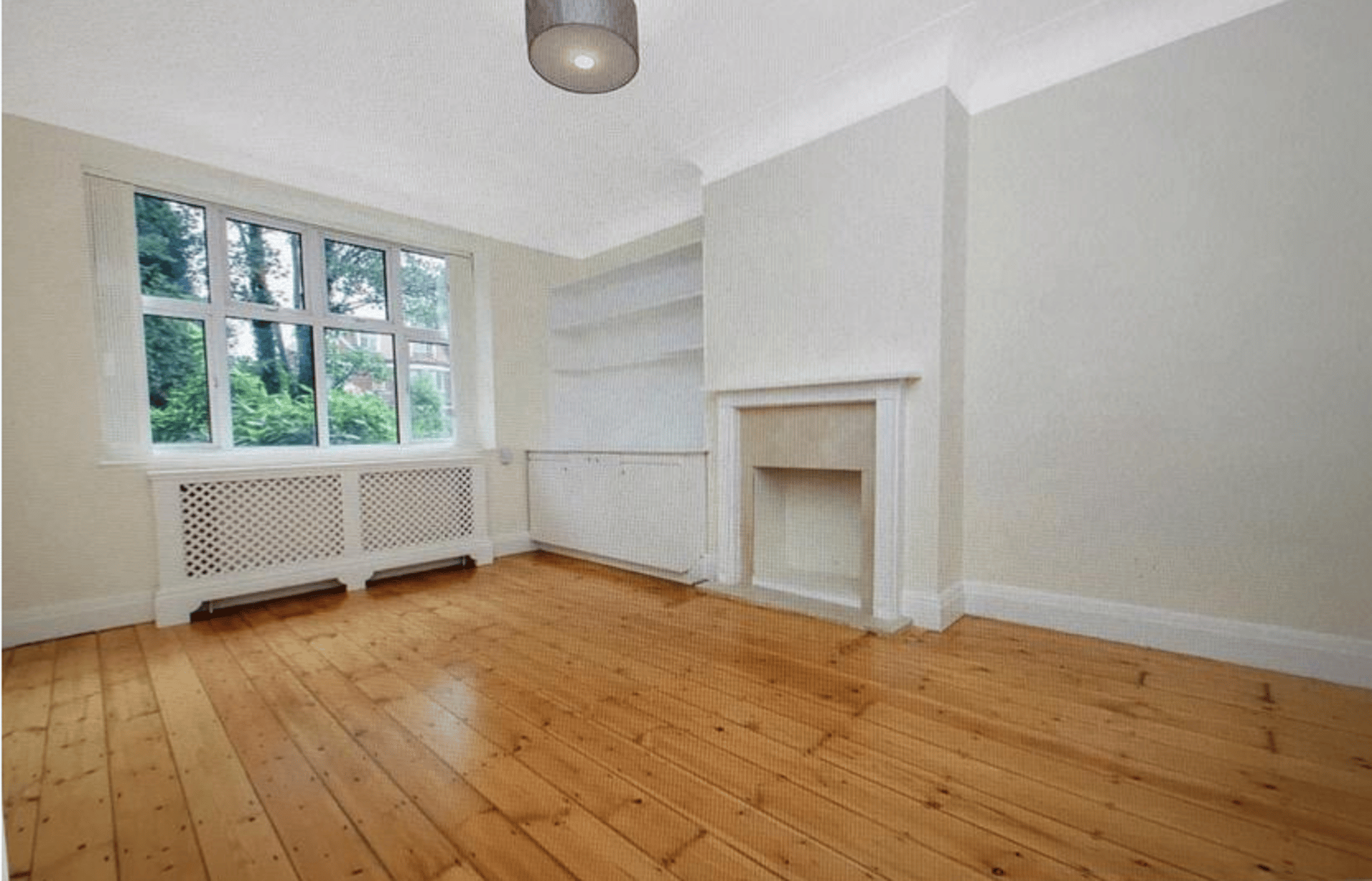 Modern office lounge area with seating and tables.
