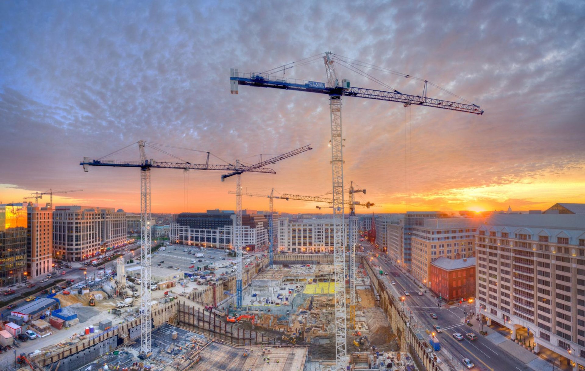 several cranes above the buildings