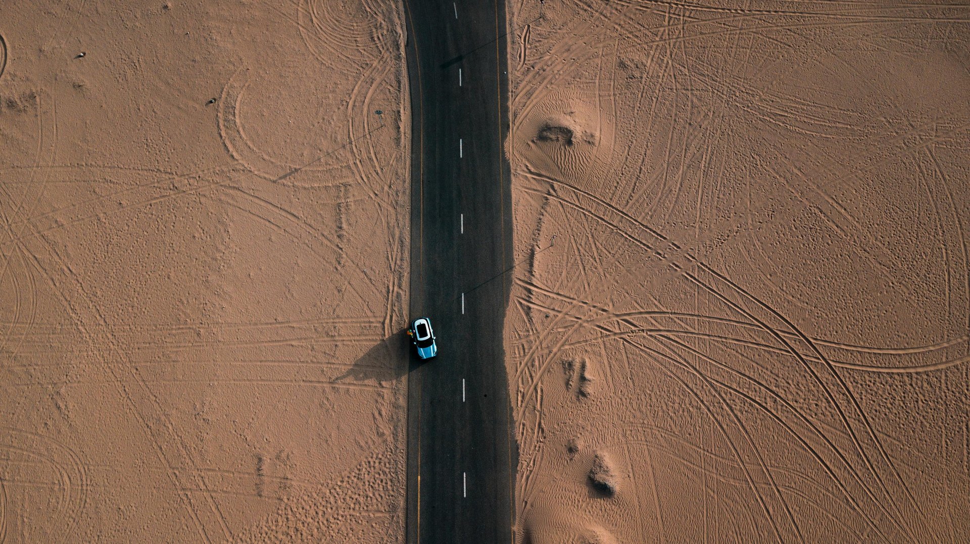 an abstract photo of a curved building with a blue sky in the background