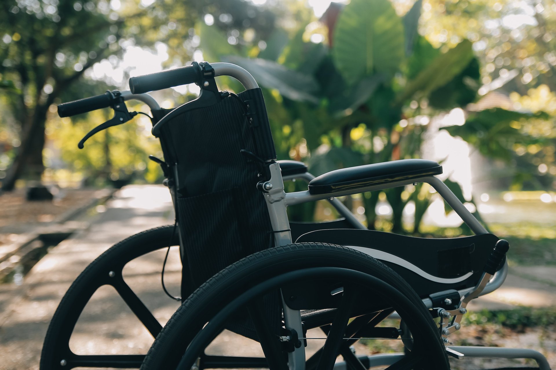 man in brown jacket and black pants riding black and red motorcycle