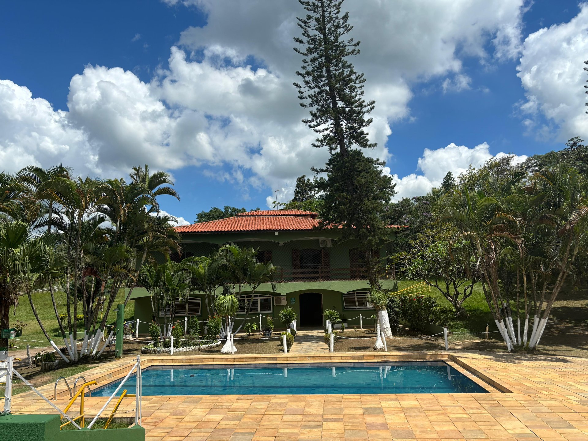 woman wearing yellow long-sleeved dress under white clouds and blue sky during daytime