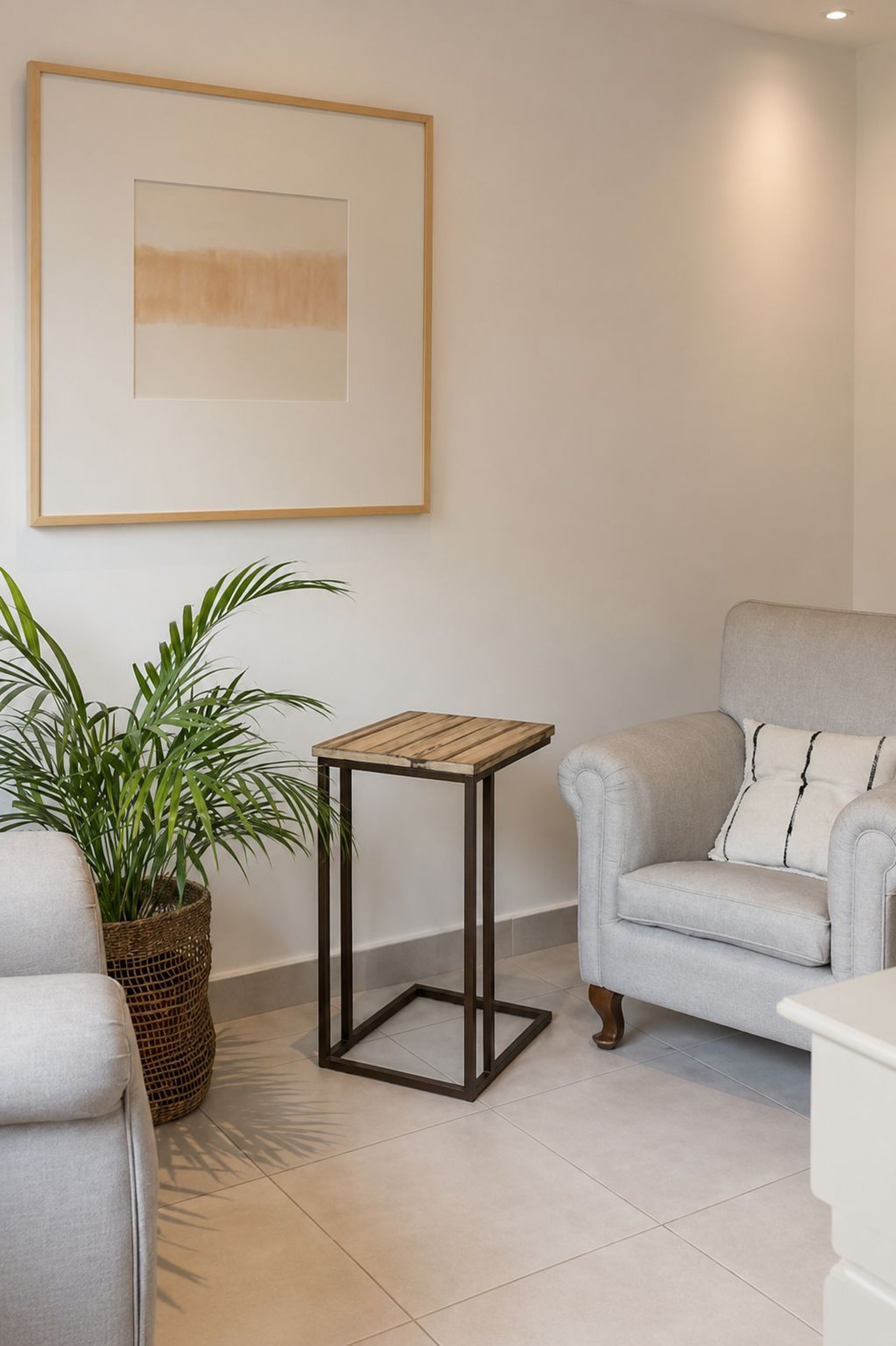 a living room filled with furniture and a painting on the wall
