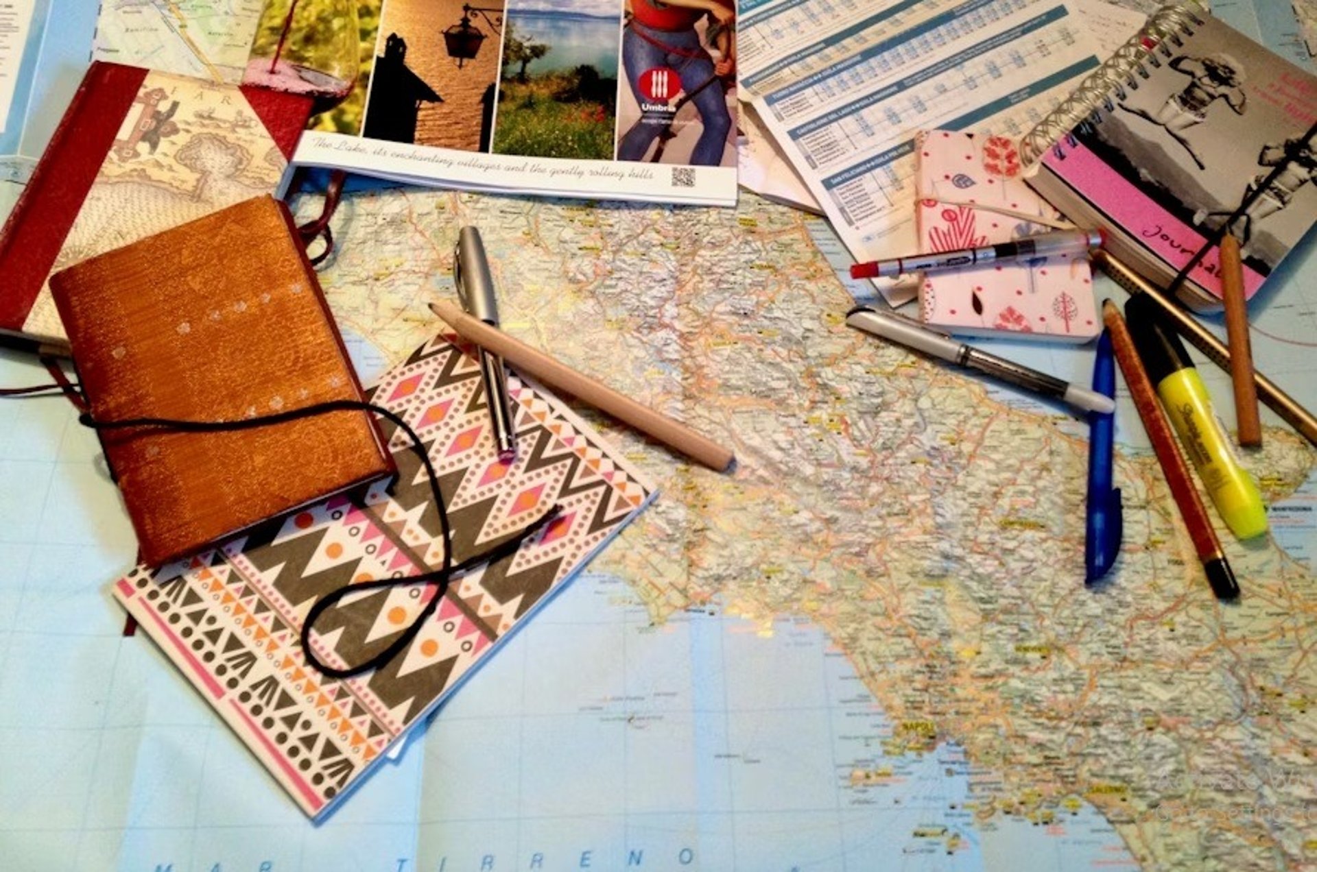 A warm photo of a friendly travel agent helping clients plan their journey with maps and brochures.