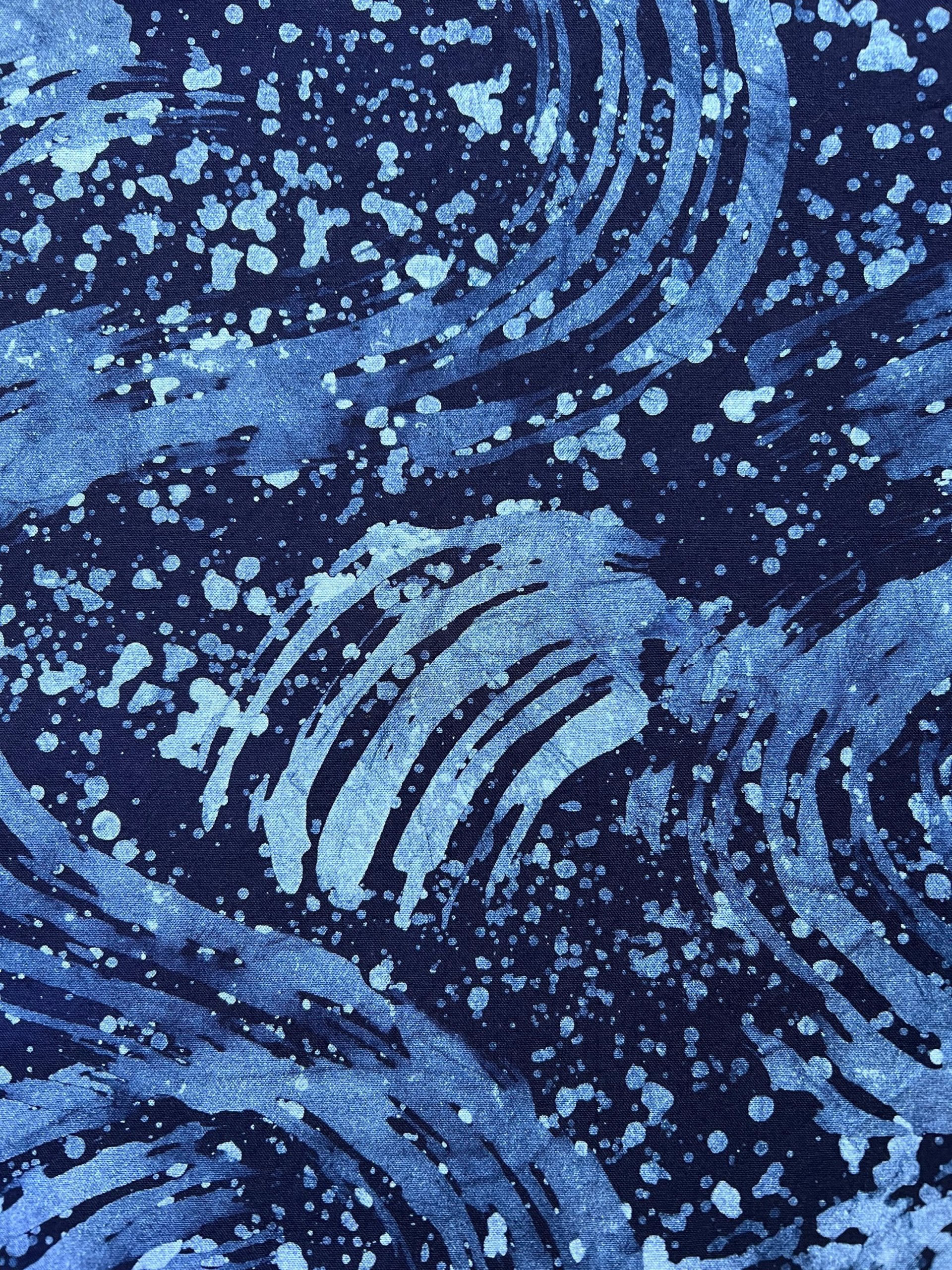 an abstract photo of a curved building with a blue sky in the background