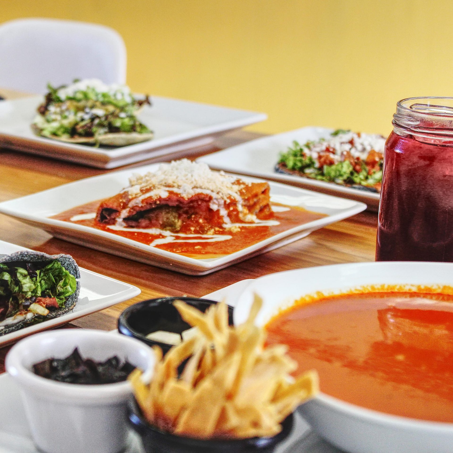 woman wearing yellow long-sleeved dress under white clouds and blue sky during daytime