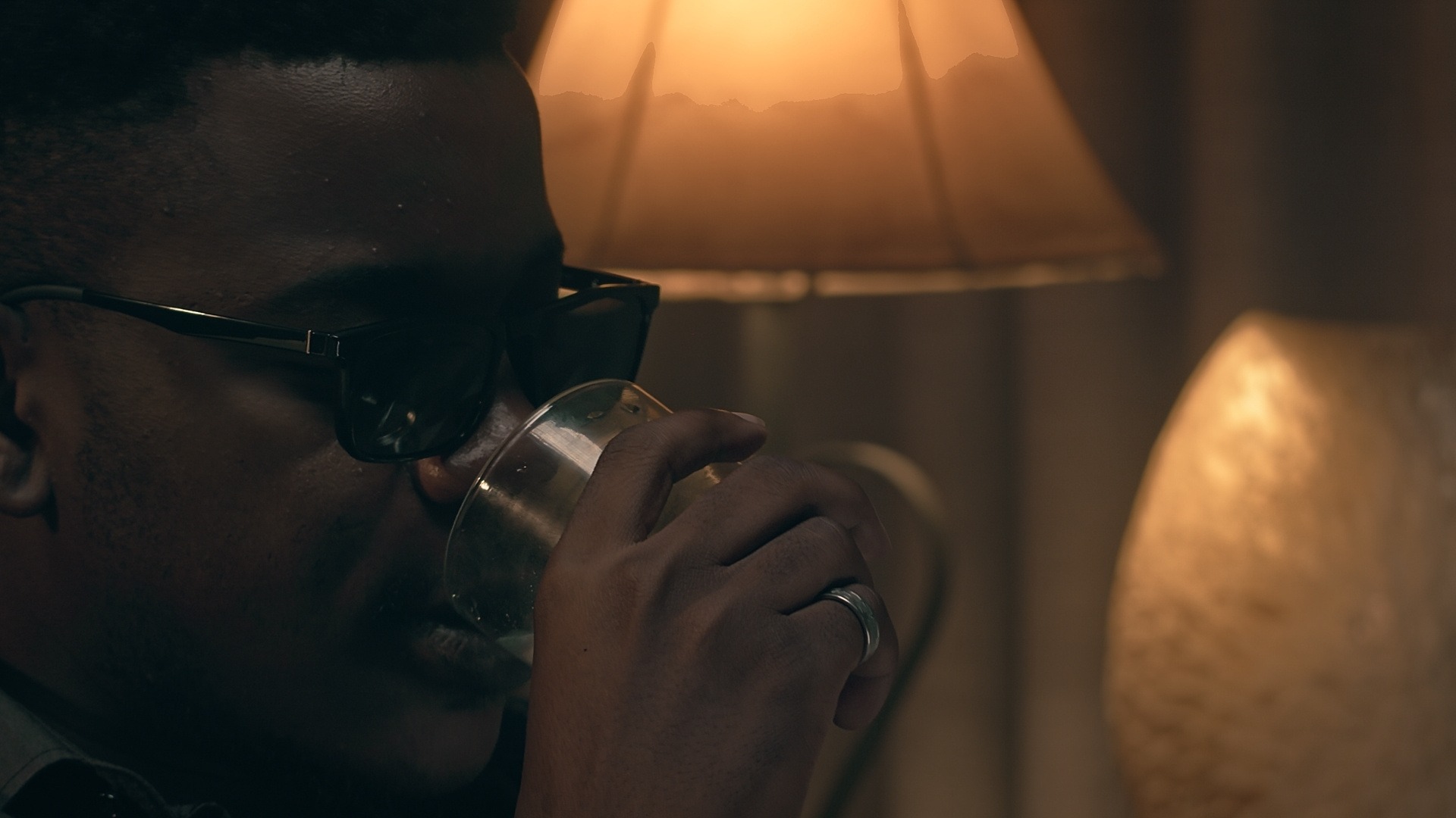 Close-up scene from the short film Grief by Daniel da Trindade showing a reflective moment in warm cinematic lighting.