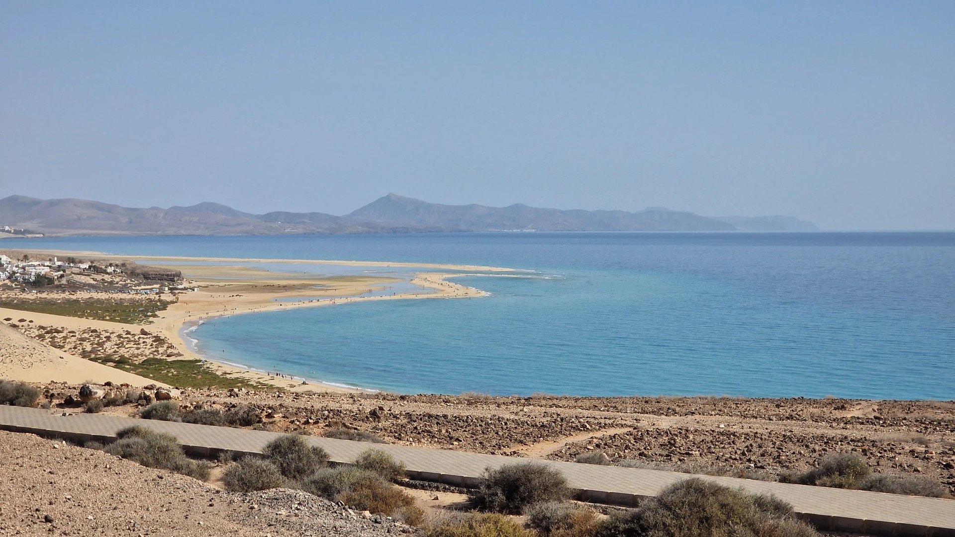 an abstract photo of a curved building with a blue sky in the background