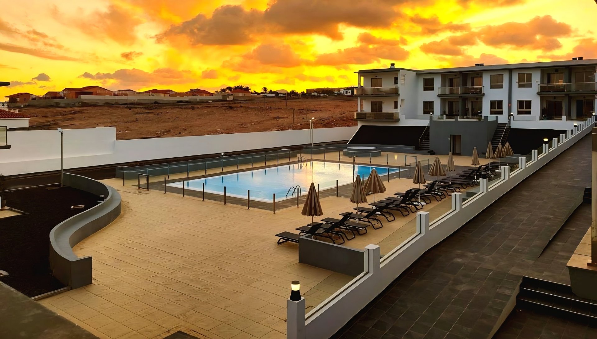 an abstract photo of a curved building with a blue sky in the background