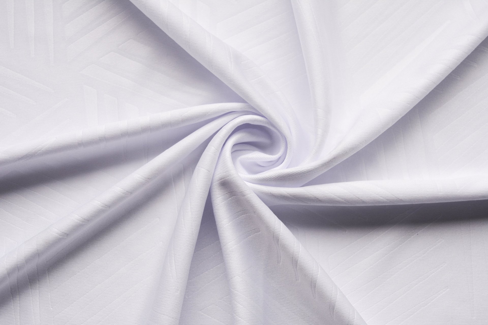 an abstract photo of a curved building with a blue sky in the background