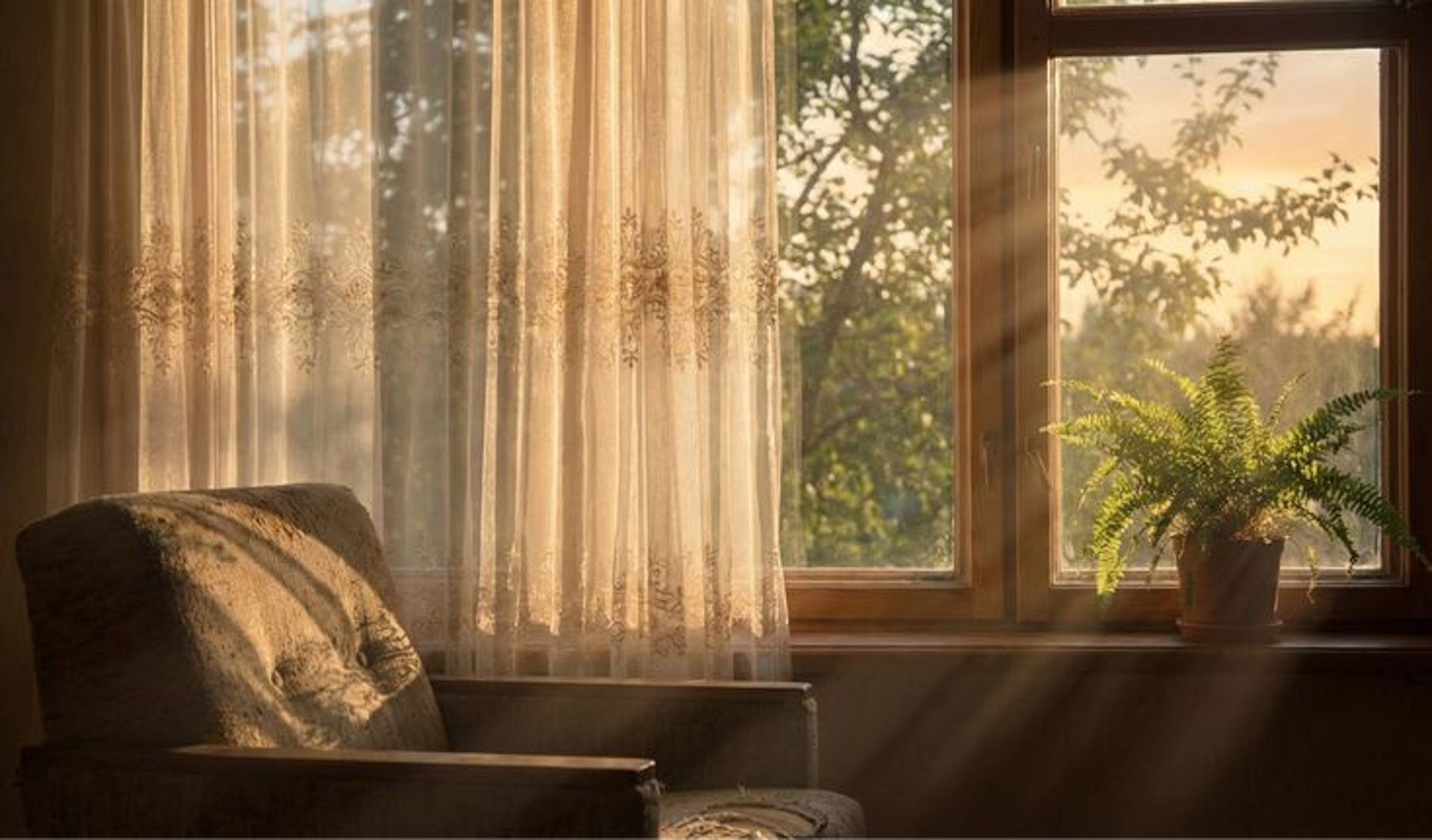 a blue chair and a yellow lamp in a white room