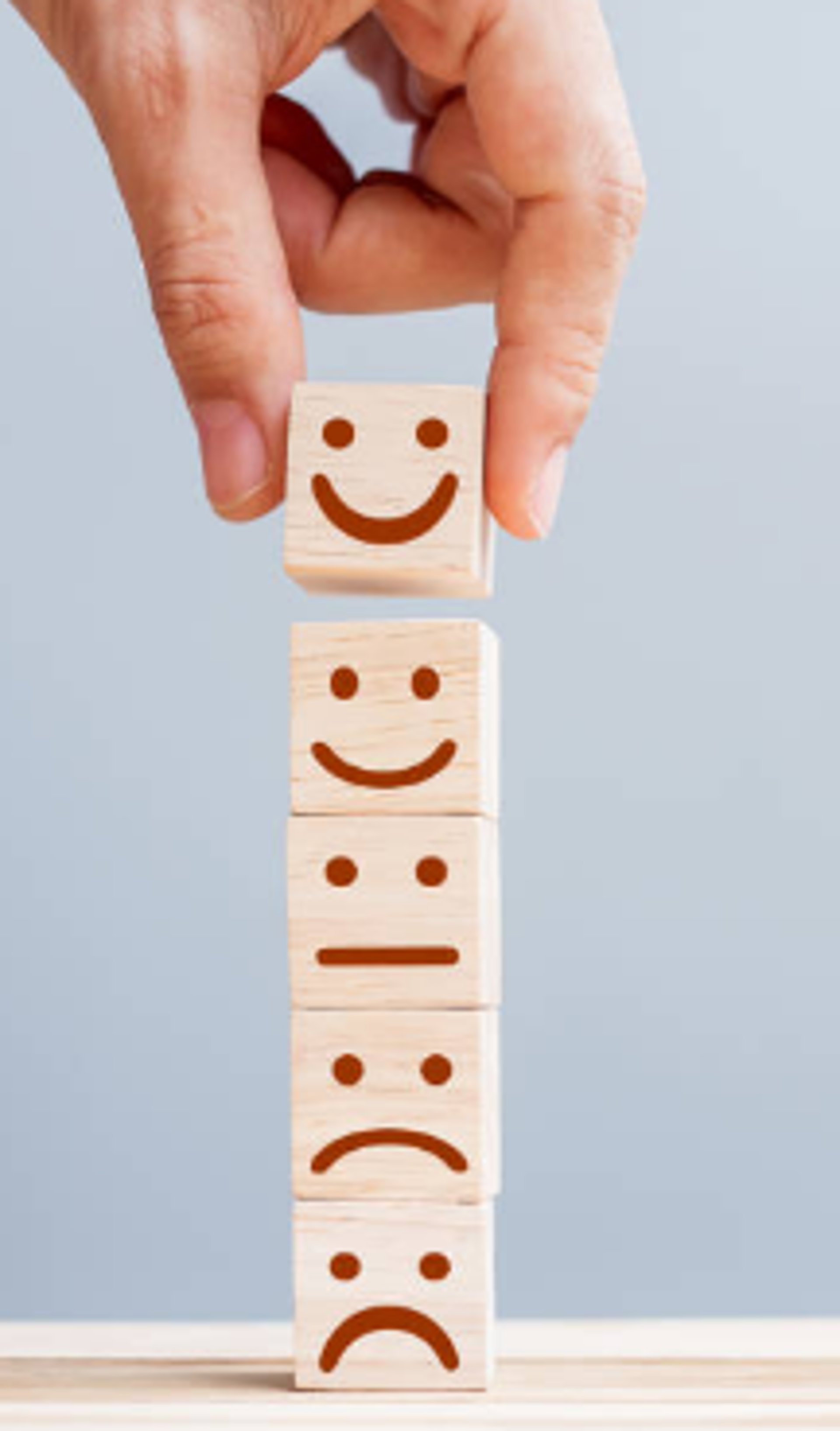 woman sitting on sofa while holding food for dog