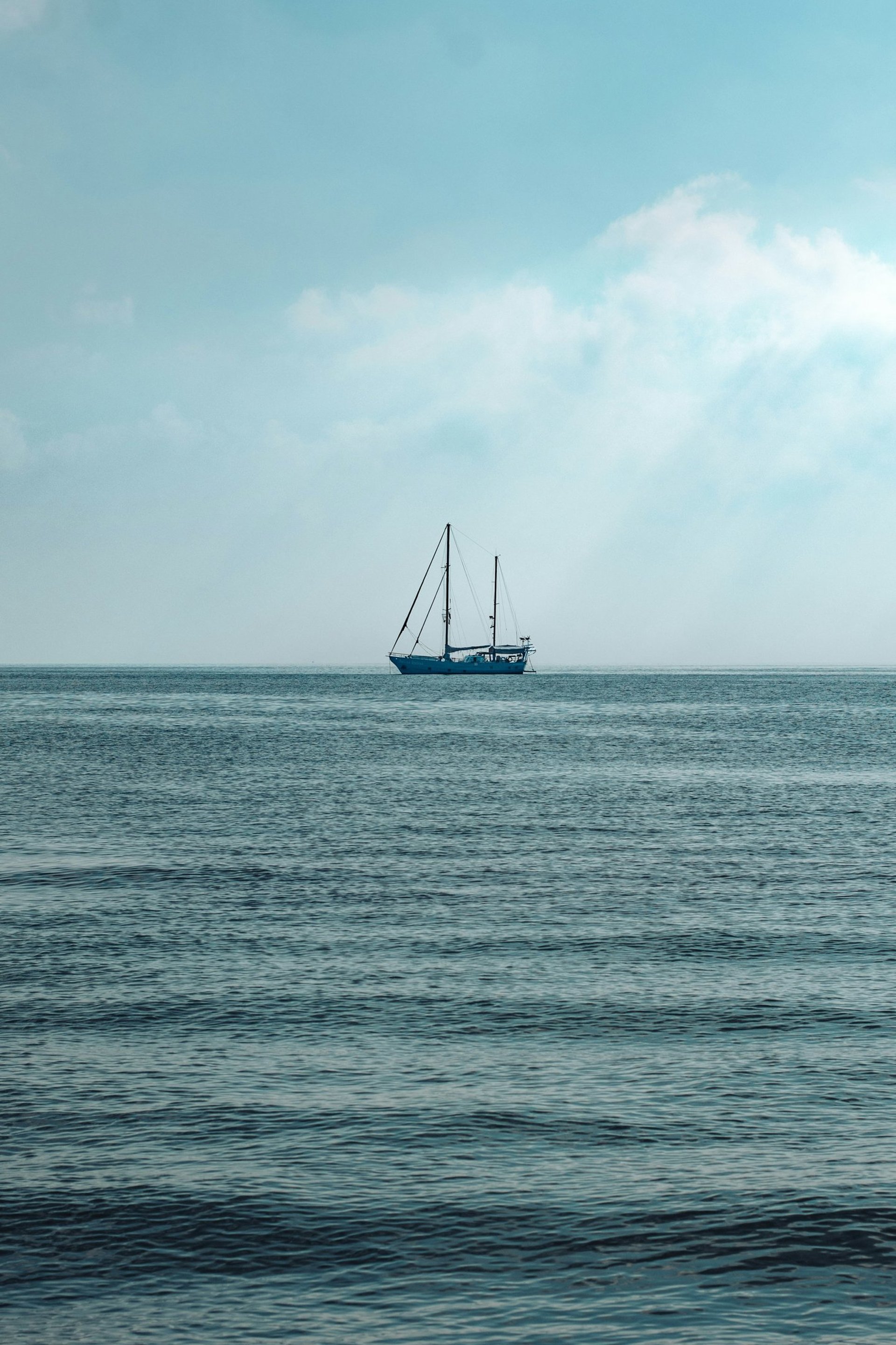 an abstract photo of a curved building with a blue sky in the background