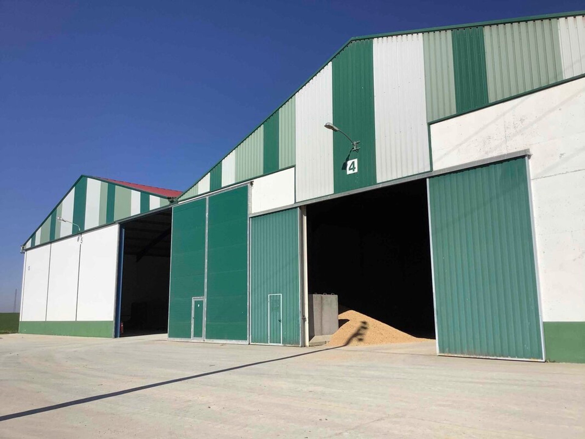 an abstract photo of a curved building with a blue sky in the background