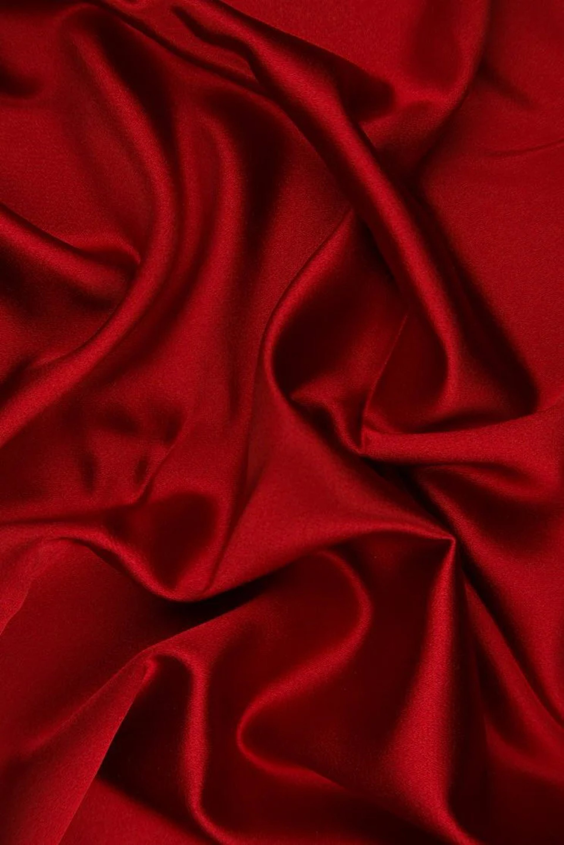 a close up of a red background with wavy lines
