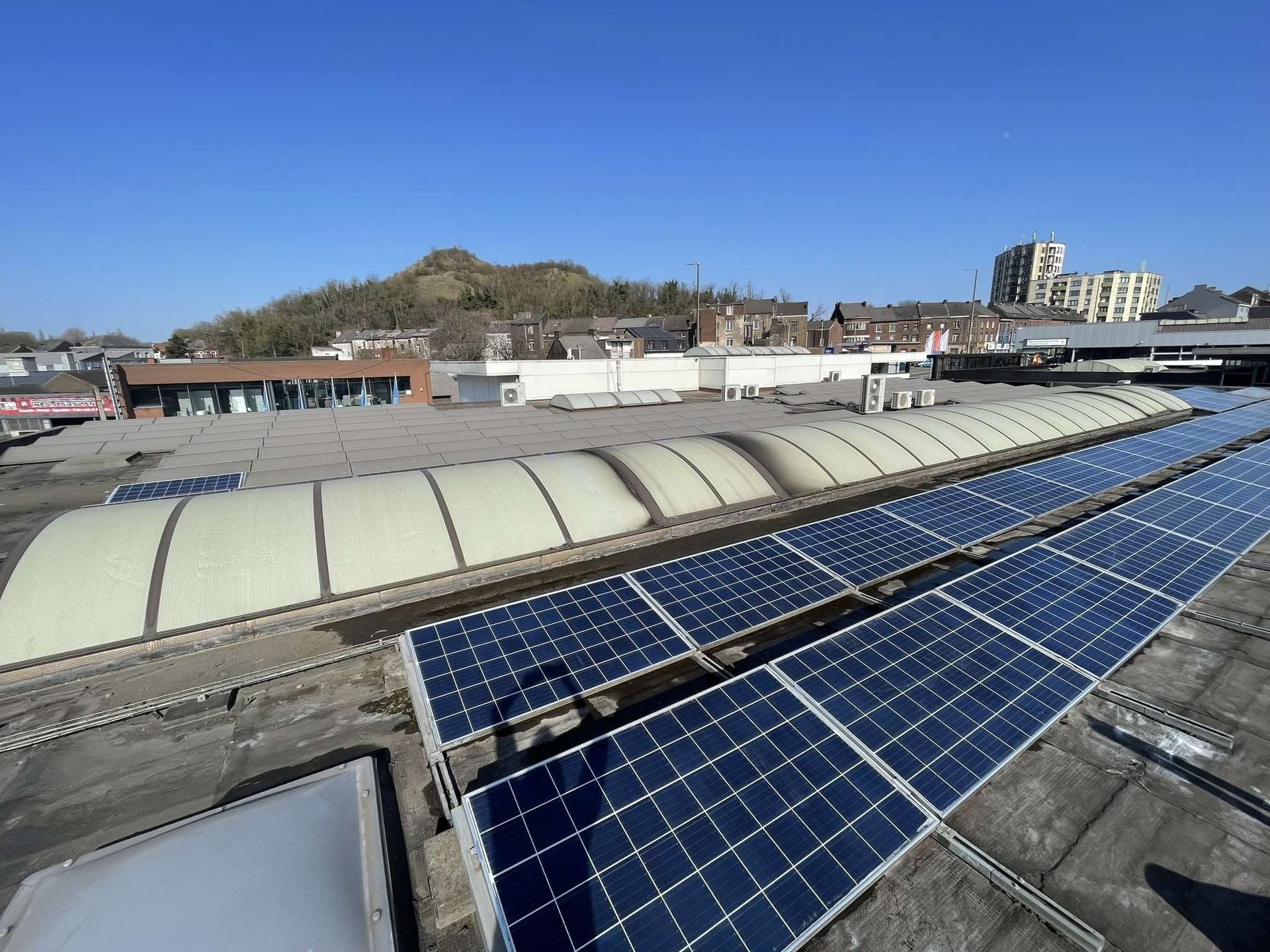 an abstract photo of a curved building with a blue sky in the background