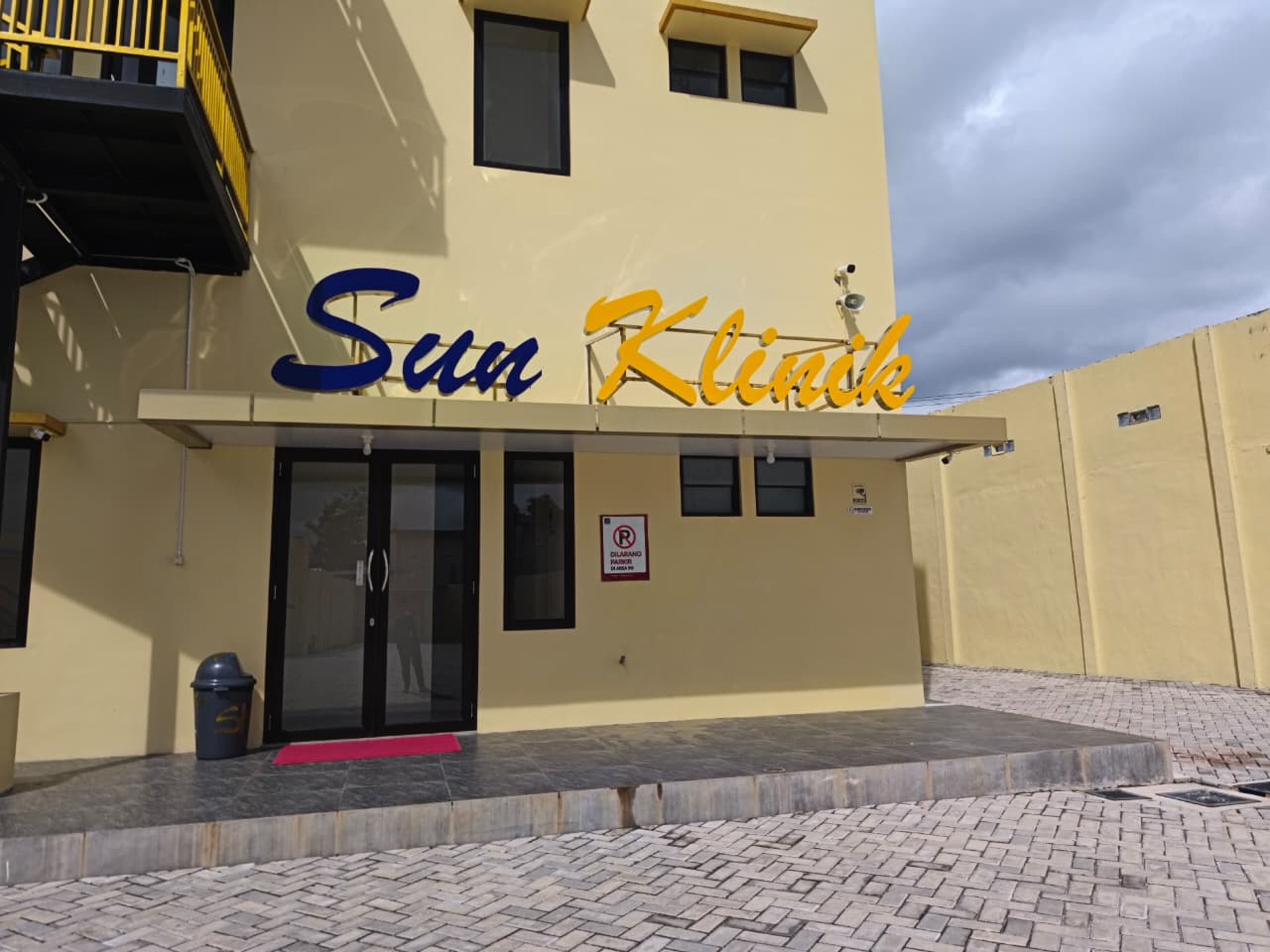 woman wearing yellow long-sleeved dress under white clouds and blue sky during daytime