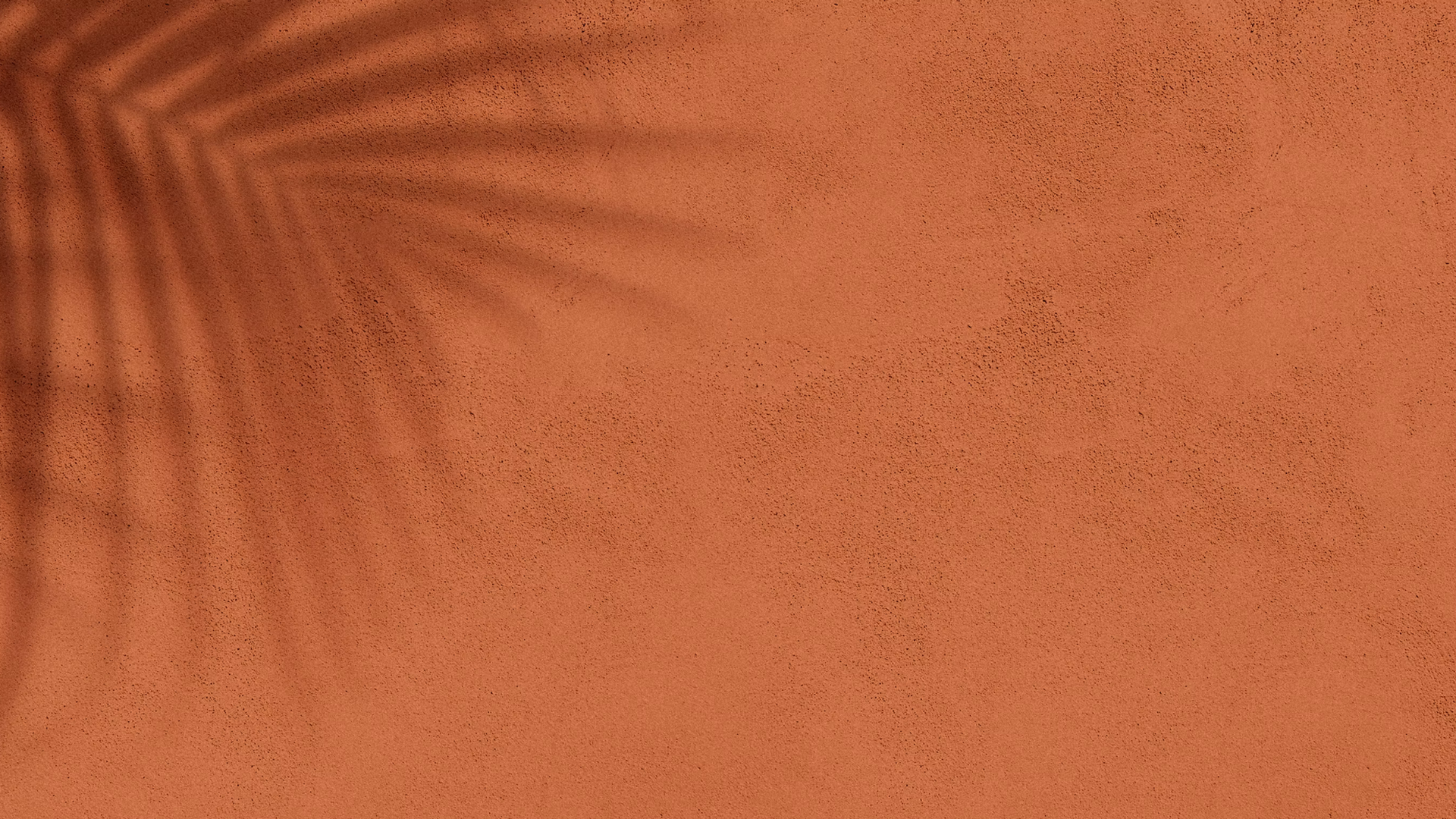 a round mirror on a wall above a wooden cabinet