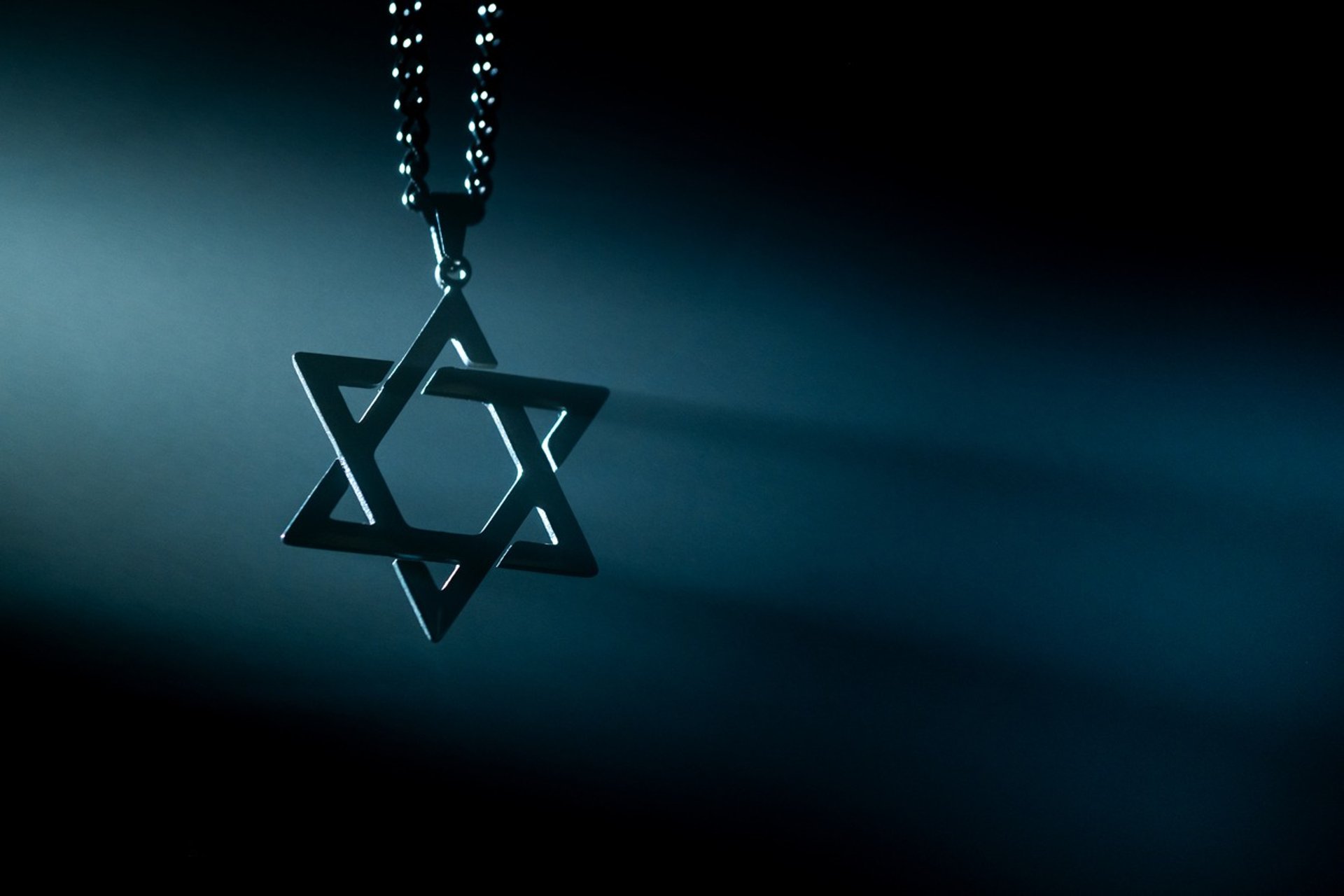 a group of people standing in front of a stone wall