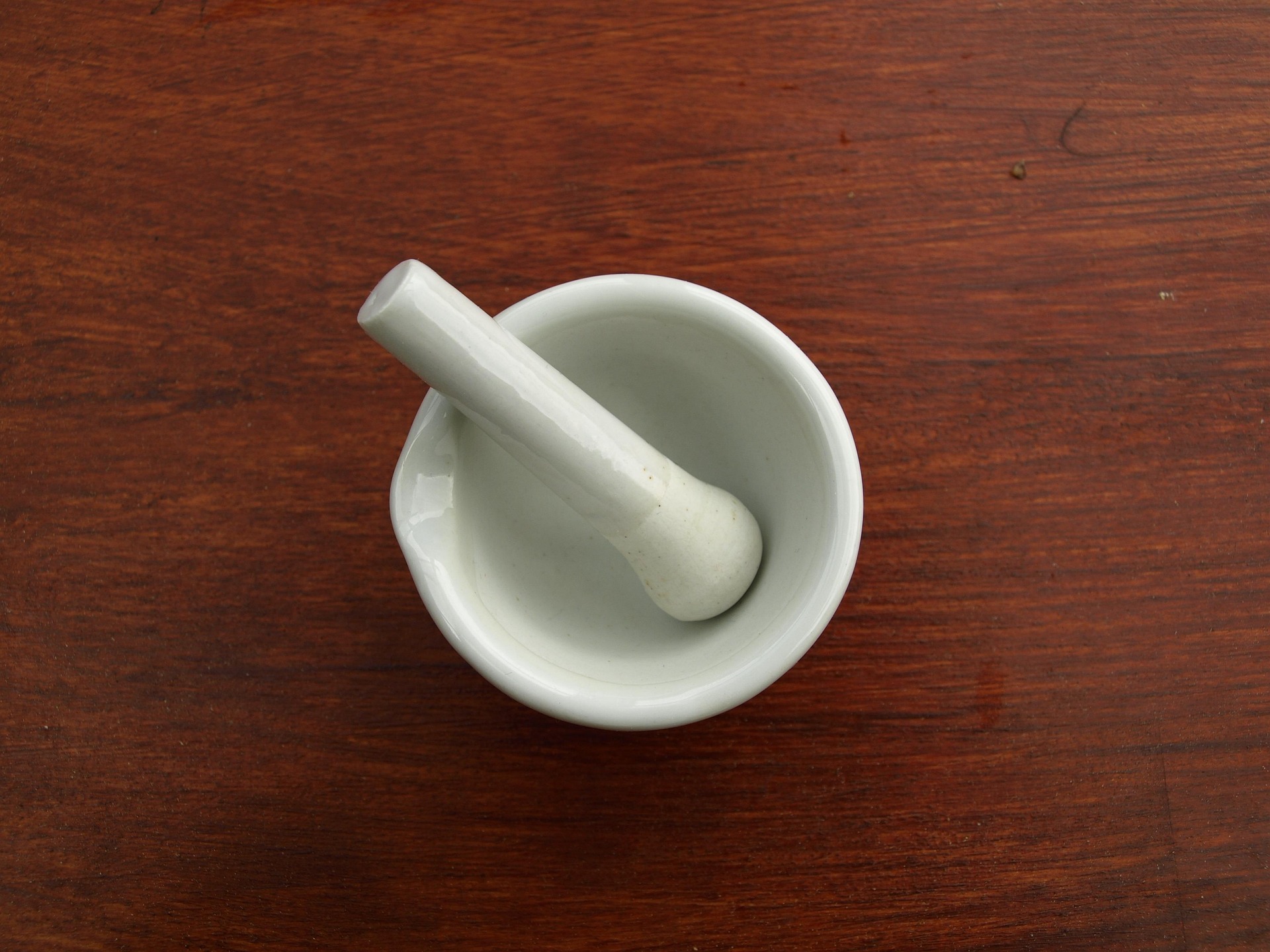 2 green ceramic mugs on brown wooden log