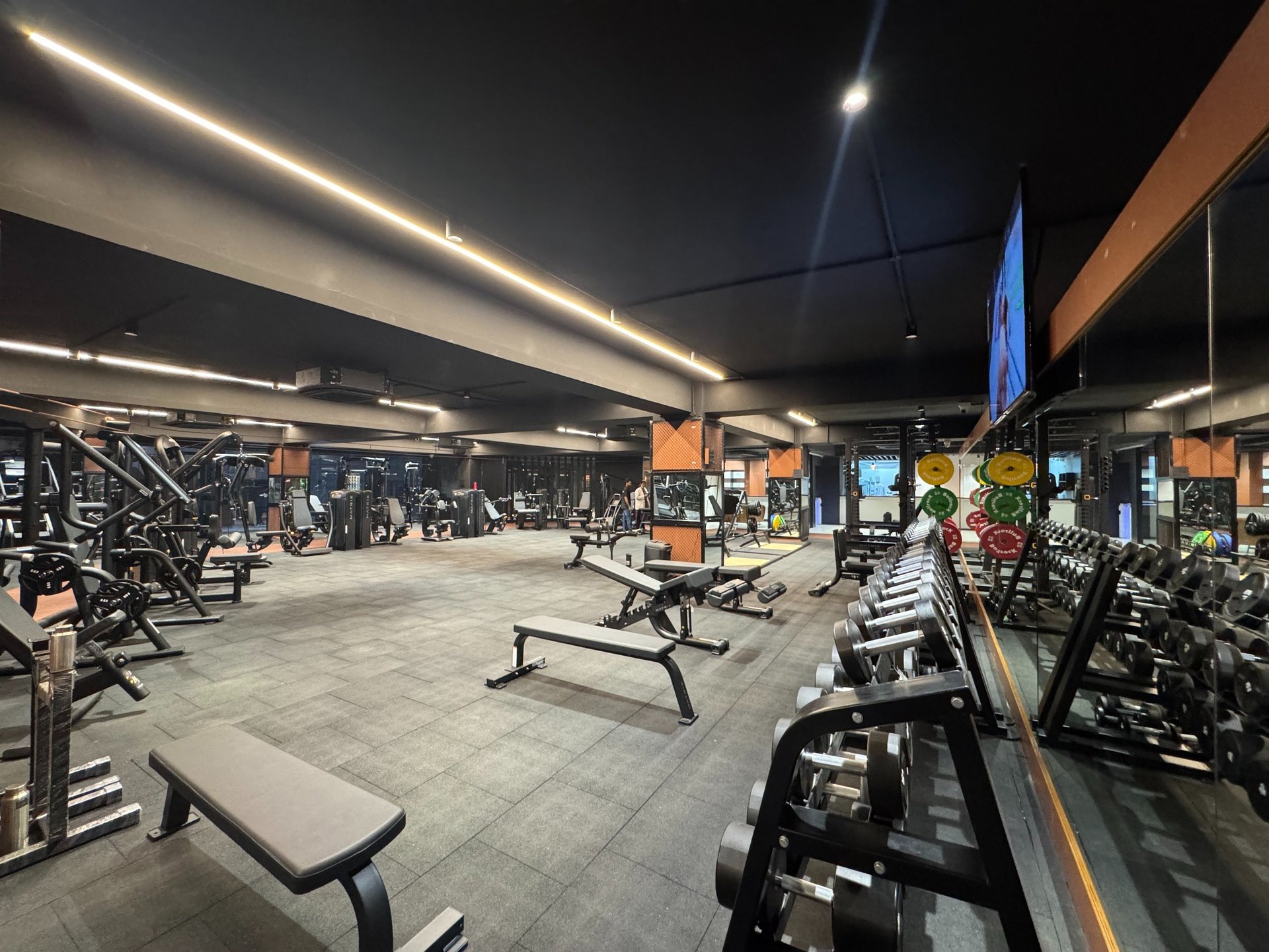 people in a room with a black table and chairs