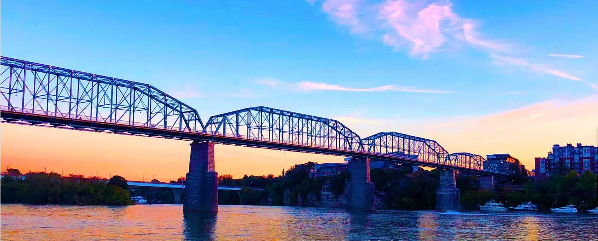 an abstract photo of a curved building with a blue sky in the background