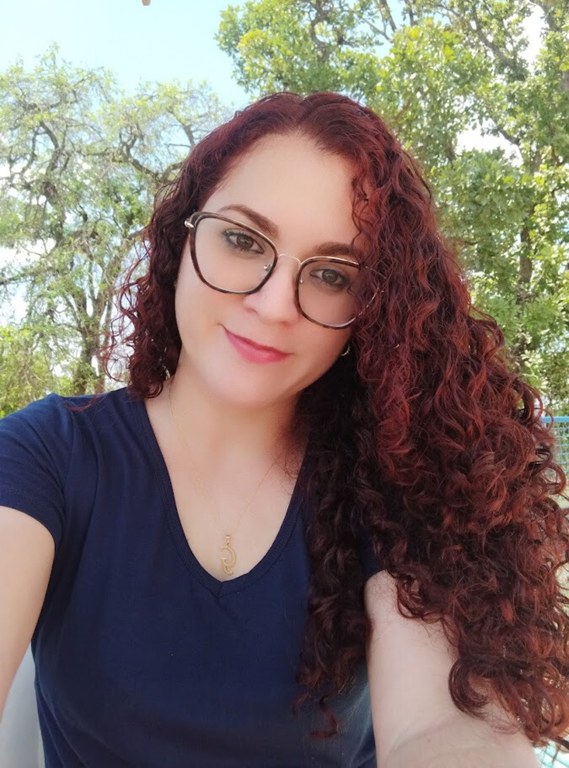 an abstract photo of a curved building with a blue sky in the background