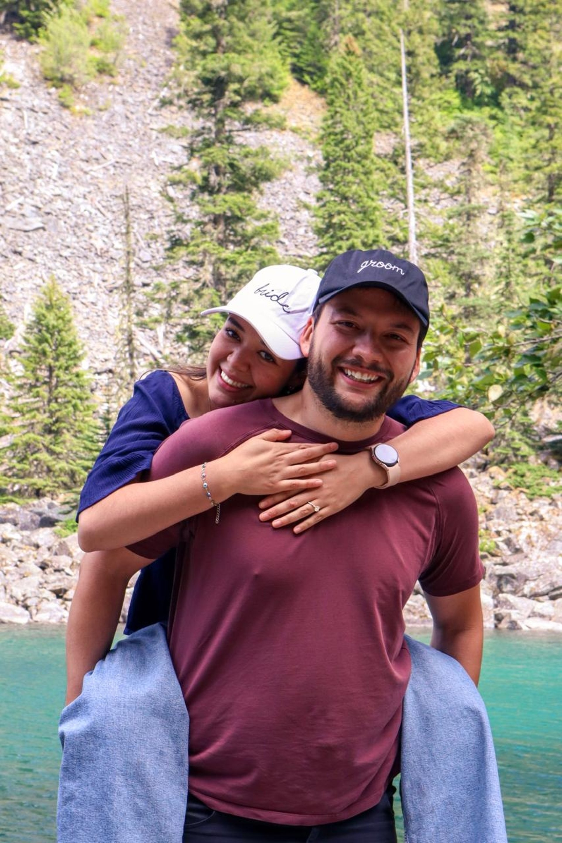 man kissing on woman forehead standing near tree during daytime