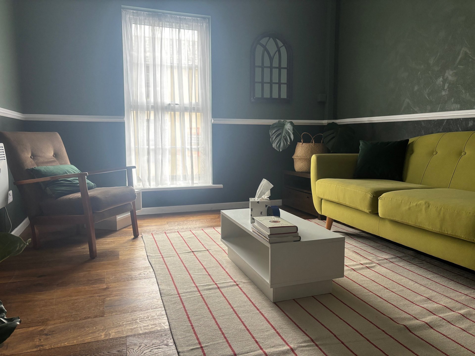 a living room with a chair and a potted plant