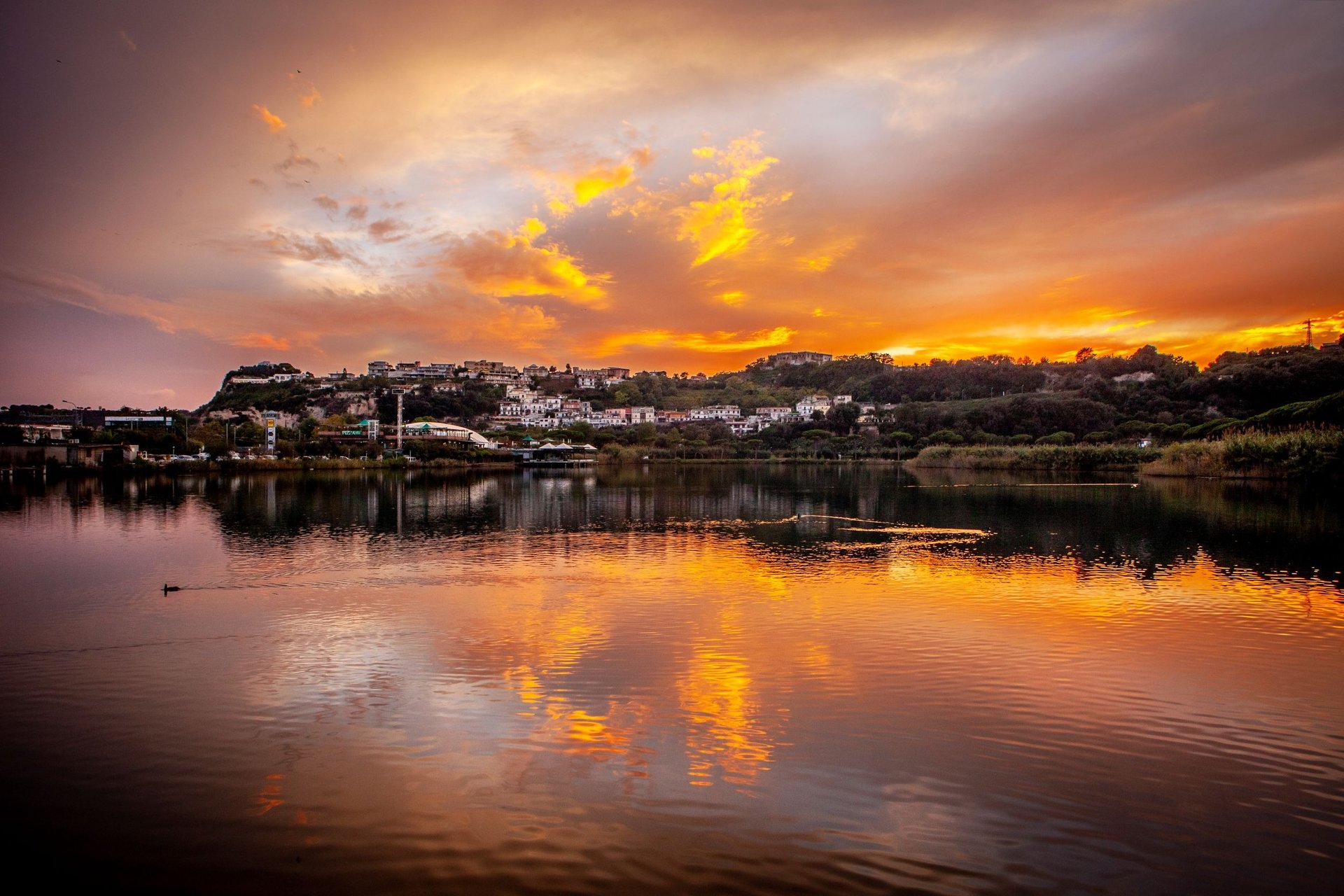 a body of water with a mountain in the distance