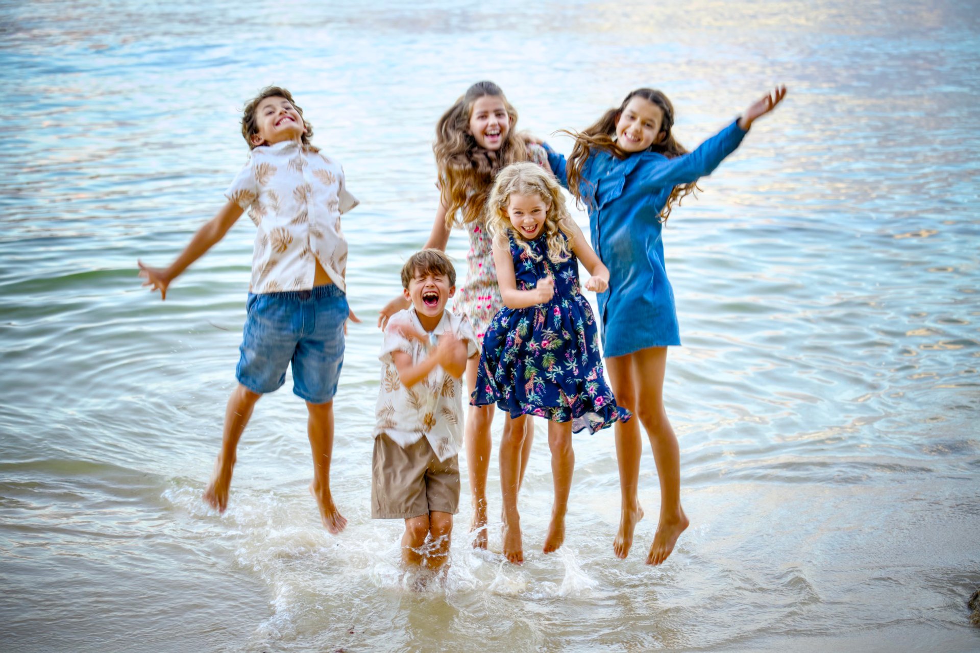 Young girl jumping with joy at Point Walter Reserve, candid children's photography Perth by Fisher Photography