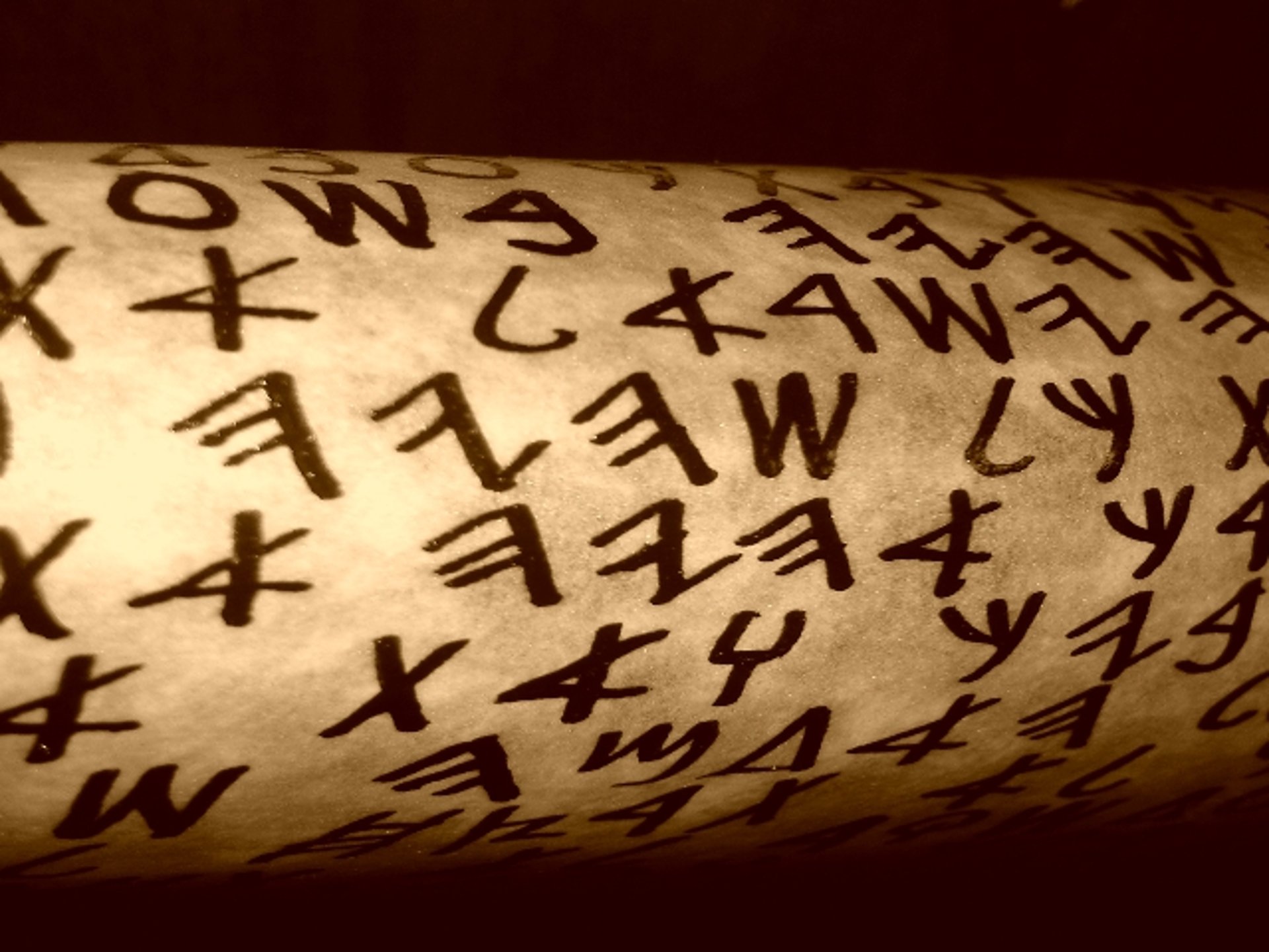 brown wooden rolling pin on white textile