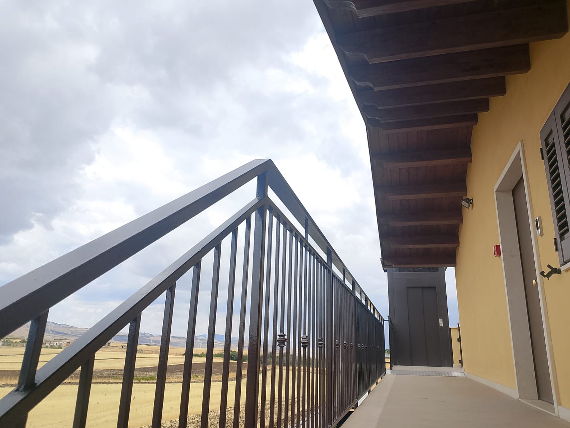 an abstract photo of a curved building with a blue sky in the background