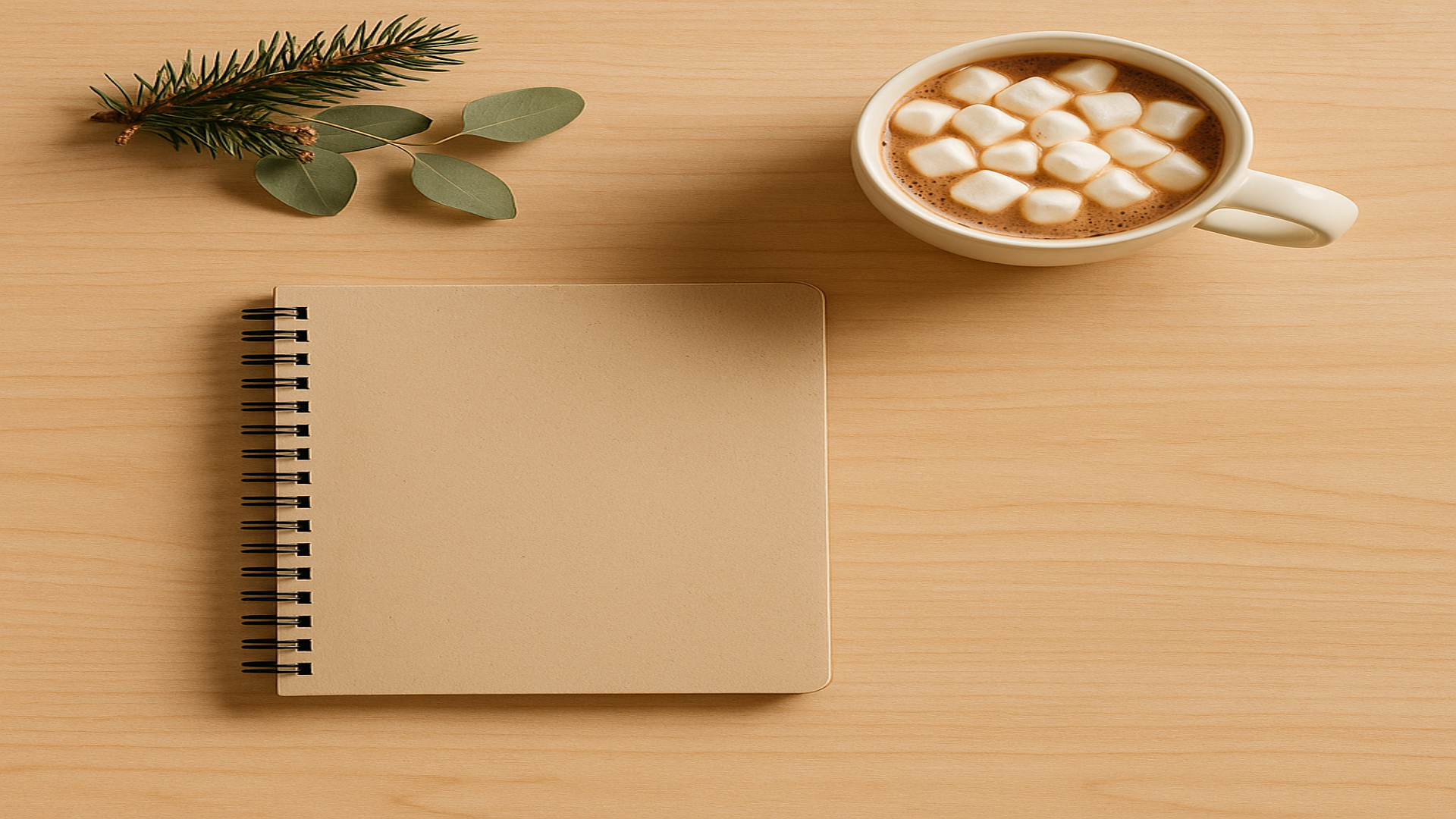 Cozy wooden desk with notebook, cocoa, and greenery.