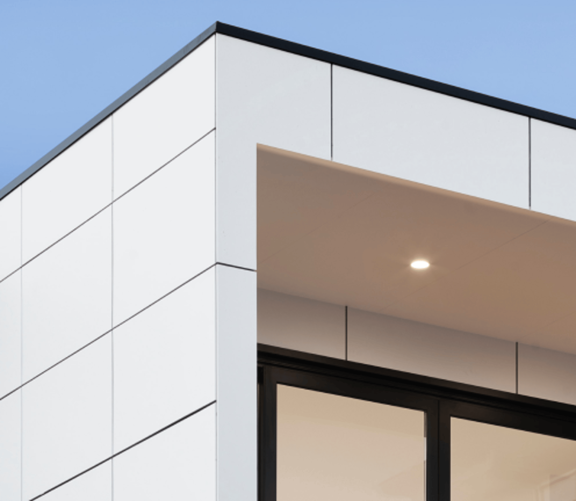 an abstract photo of a curved building with a blue sky in the background