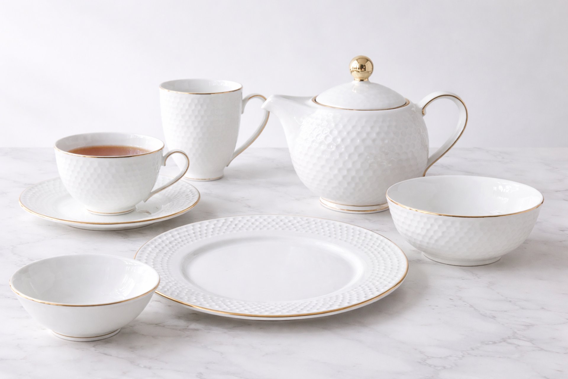 Table setting with silverware, plates, and glasses.
