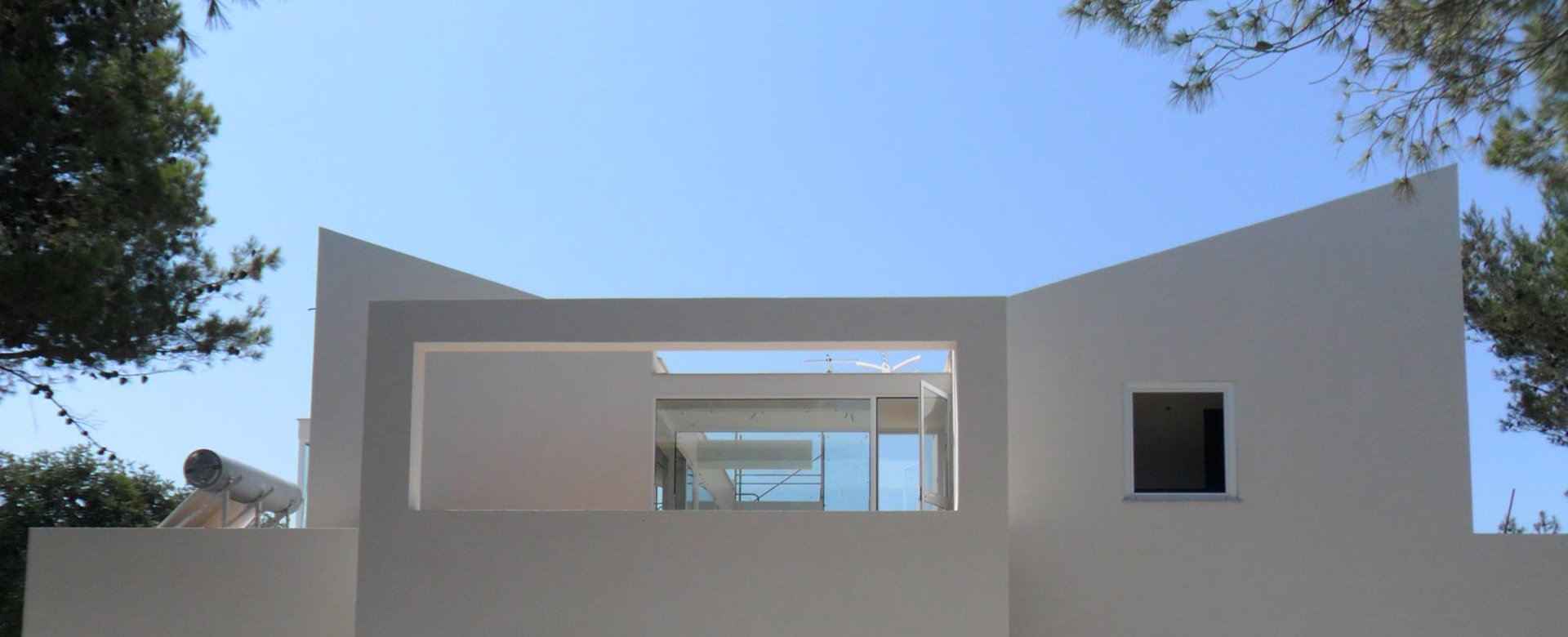 an abstract photo of a curved building with a blue sky in the background