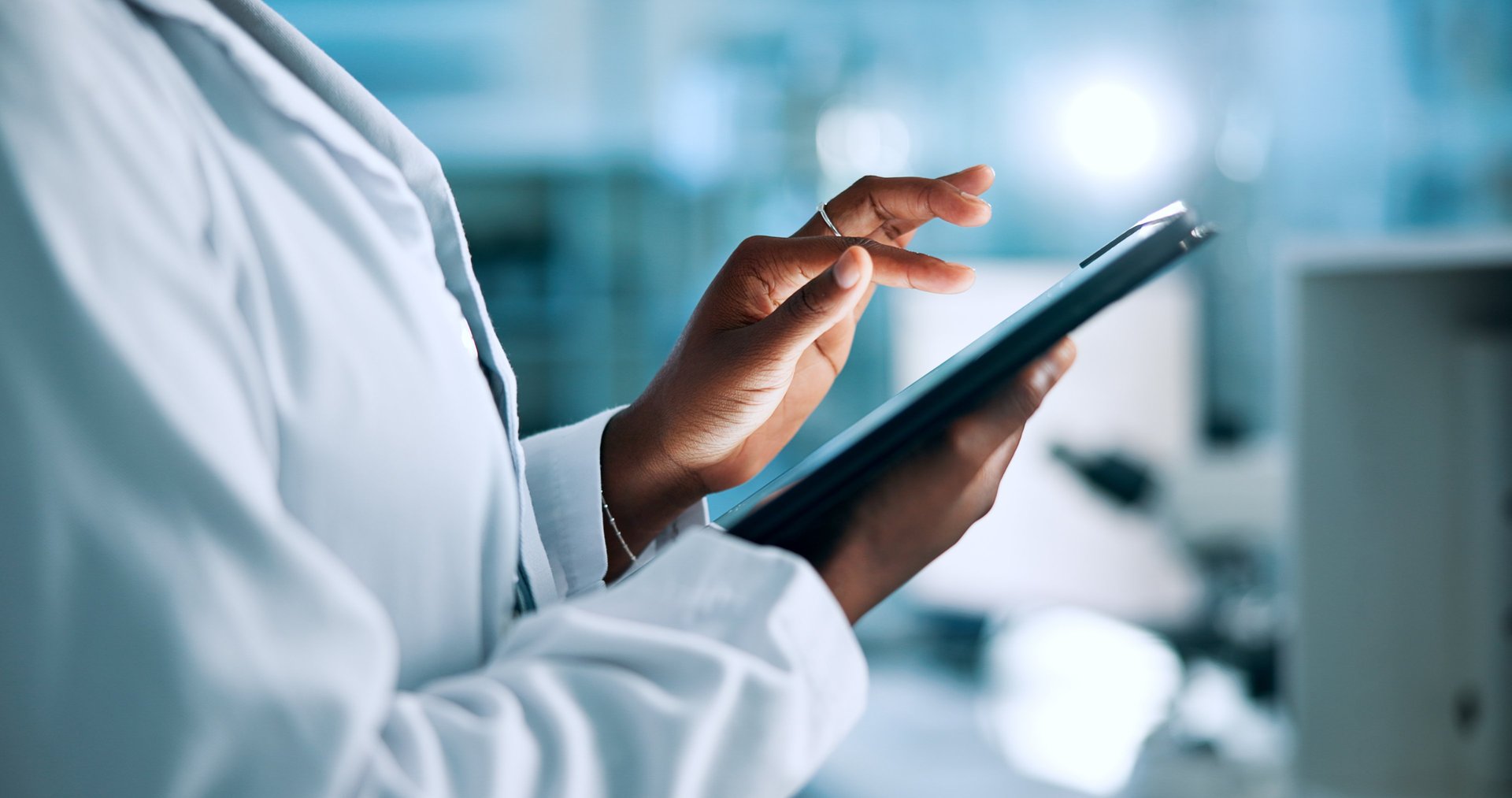Close-up of a doctor using billing app on ipad