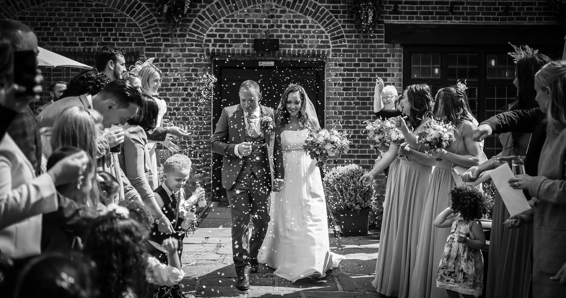 newly-weds having their confetti moment at Tudor barn Eltham